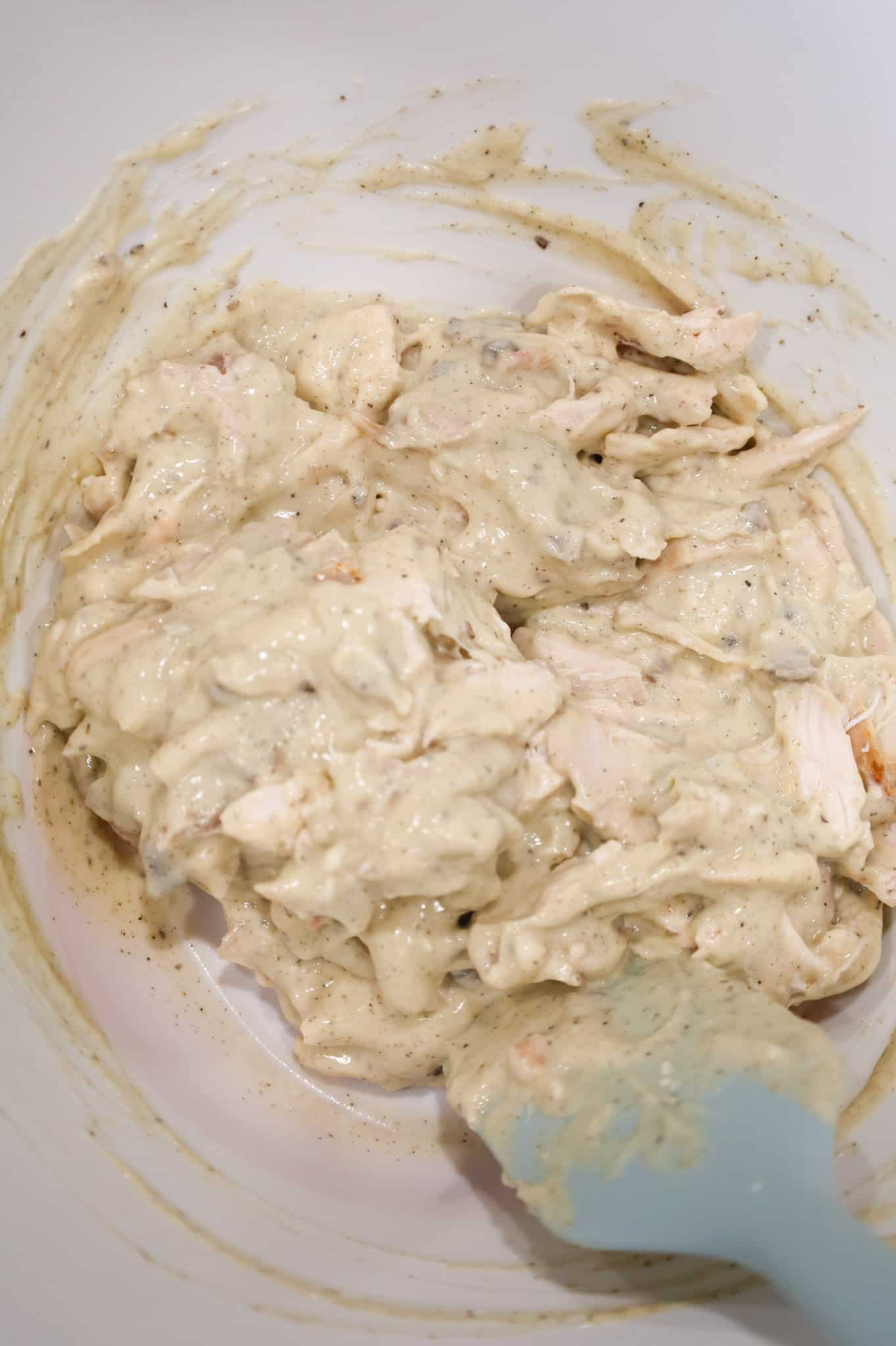 shredded chicken and cream soup mixed together in a bowl.