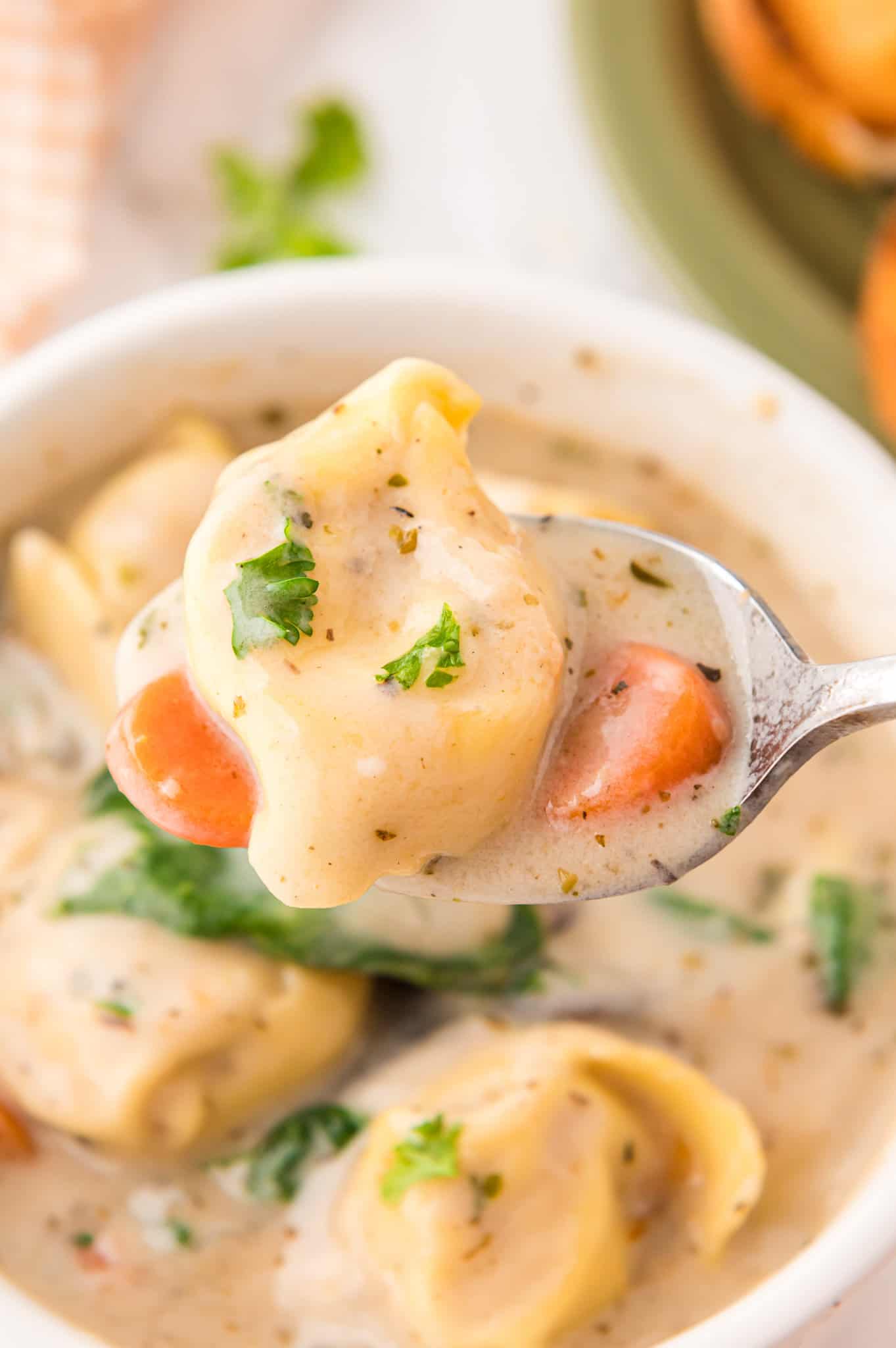 Creamy Tortellini Soup with Sausage is a hearty soup recipe loaded with store bought tortellini, chunks of sausage, mushrooms, carrots and spinach.