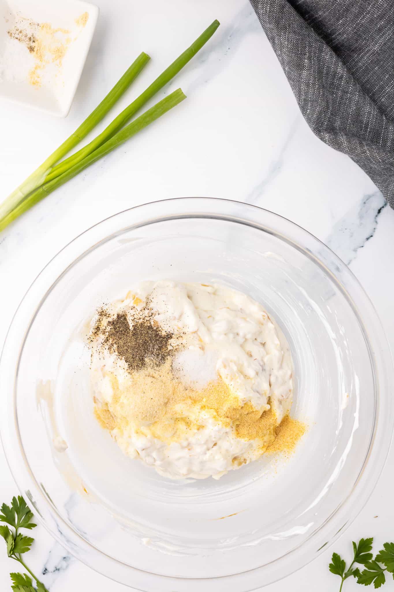 onion powder, garlic powder, salt and pepper added to bowl with sour cream mixture