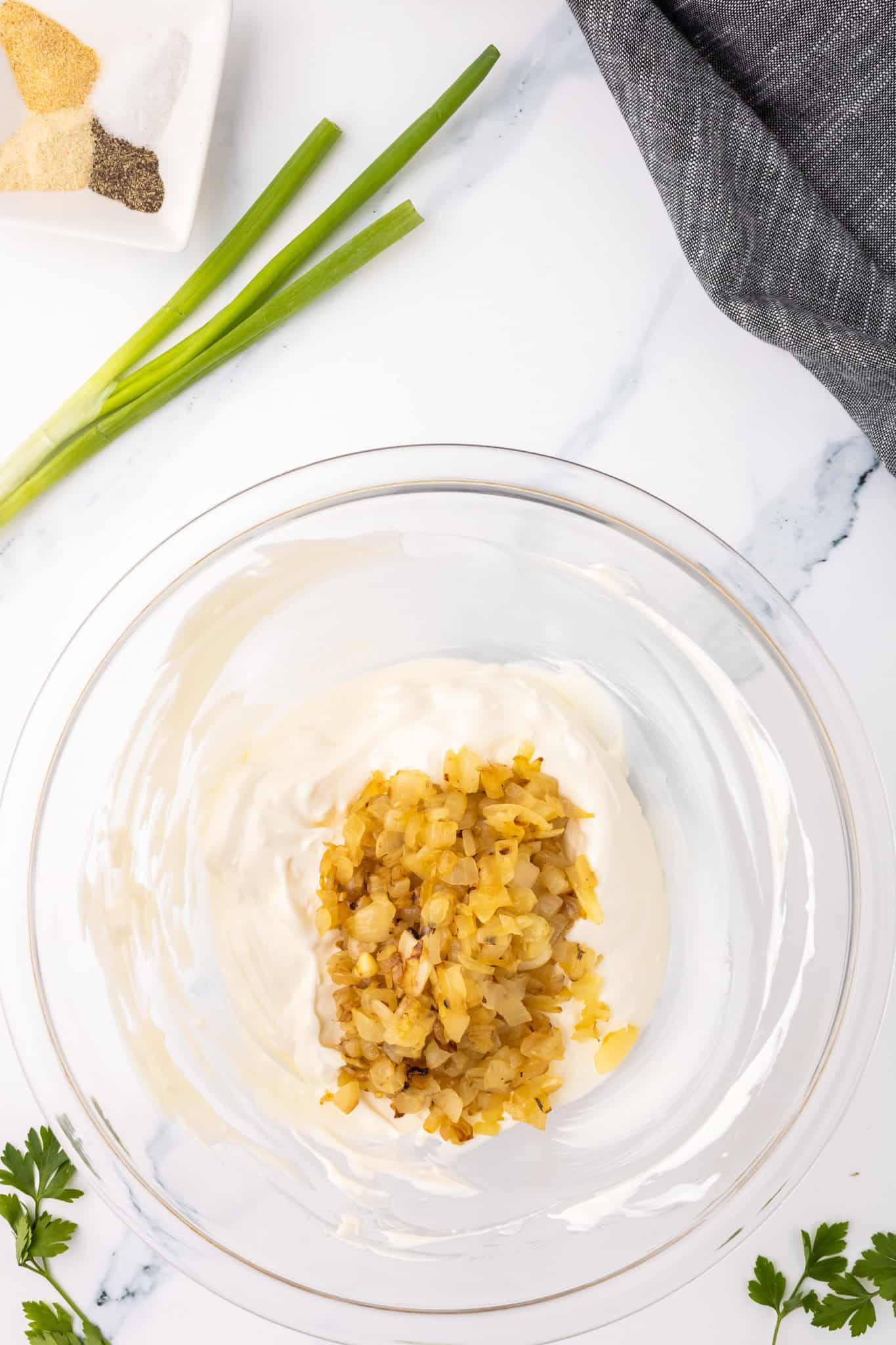 caramelized onions added to bowl with sour cream mixture