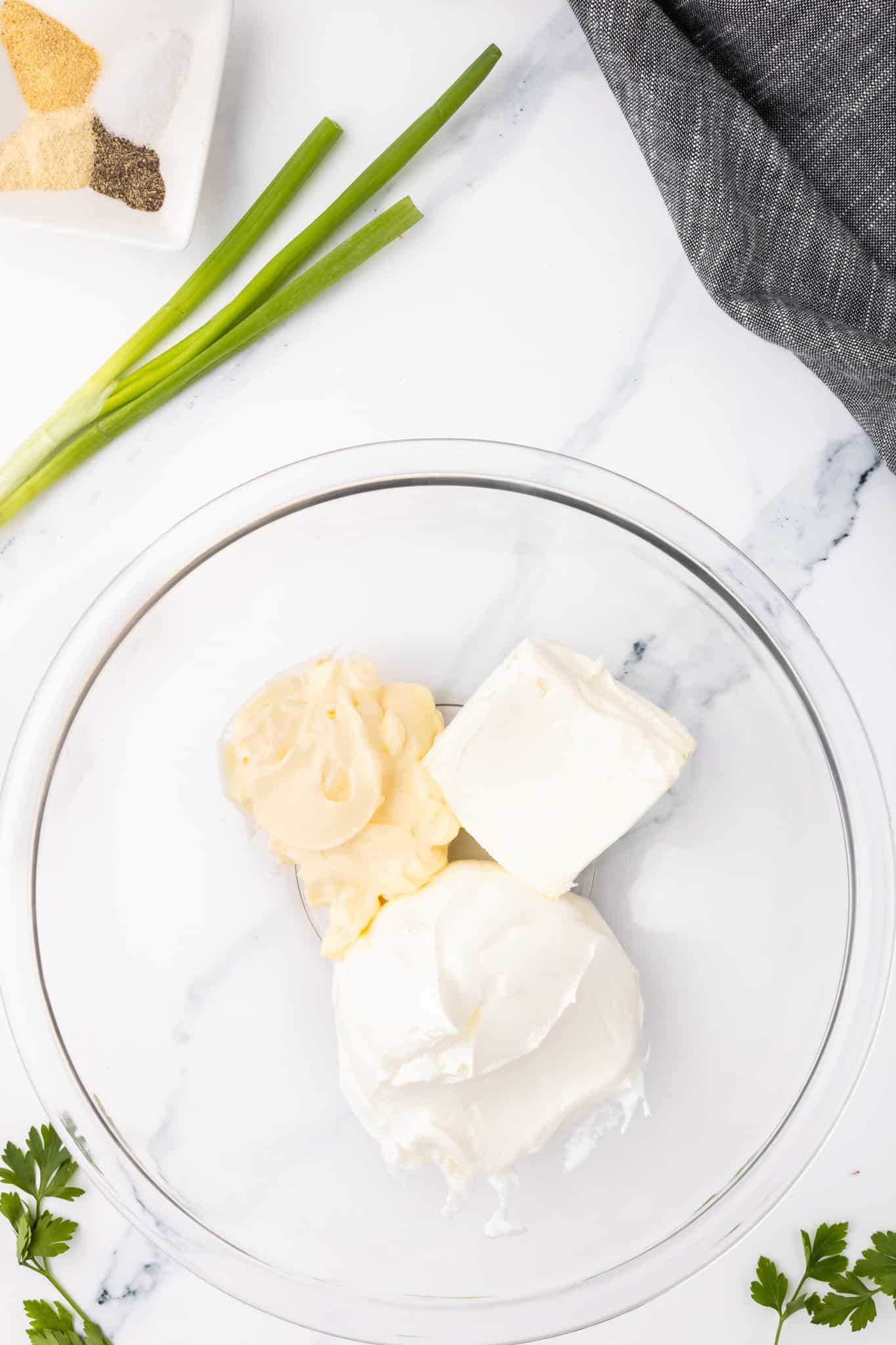 sour cream, mayo and cream cheese in a bowl