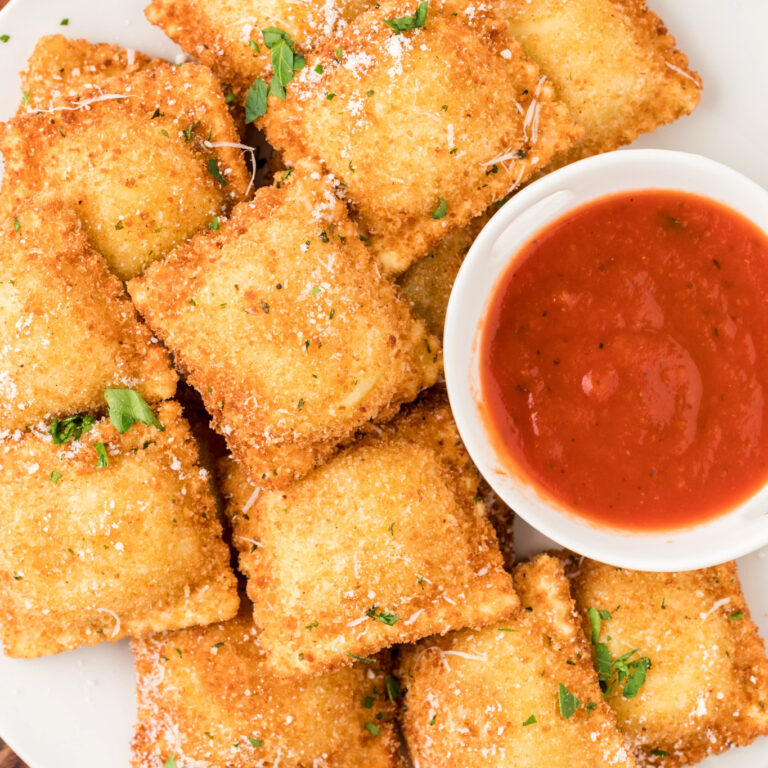 Fried Ravioli are a delicious appetizer made with store bought ravioli coated in an Italian breadcrumb and Parmesan cheese mixture and fried until golden brown and crispy.