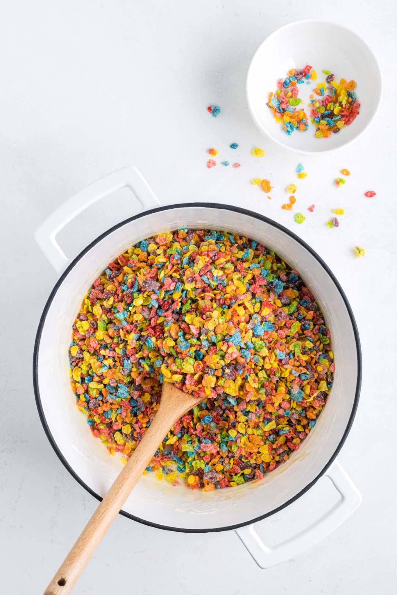 fruity pebbles added to pot with butter and marshmallow mixture