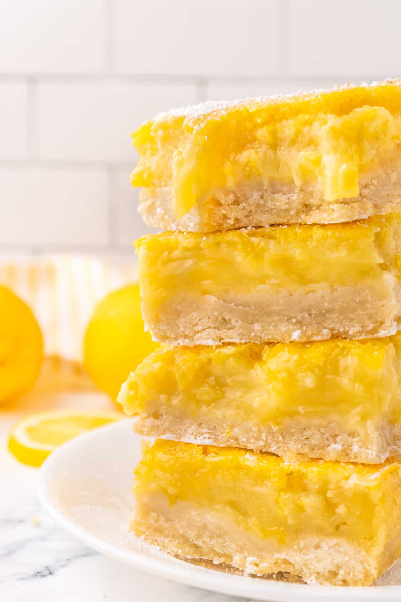 Lemon Bars are a decadent dessert with a shortbread like base topped with a smooth, rich lemon layer.