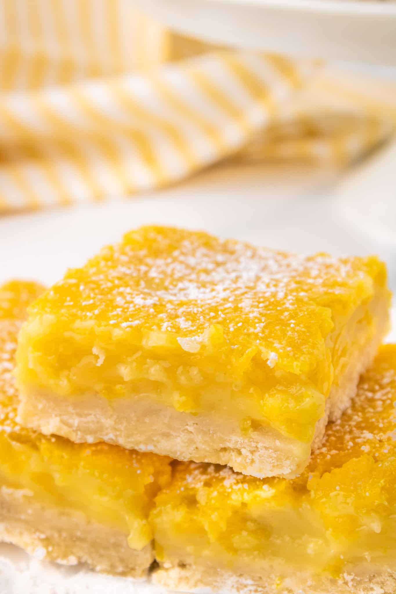 Lemon Bars are a decadent dessert with a shortbread like base topped with a smooth, rich lemon layer.