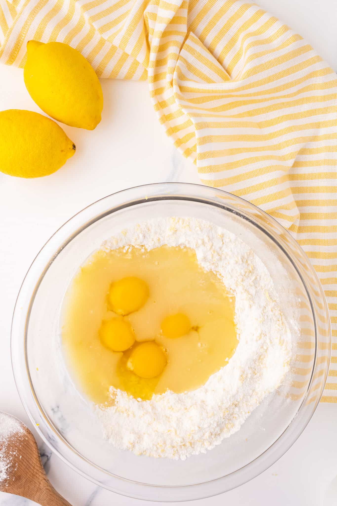 eggs added to bowl with flour and sugar mixture