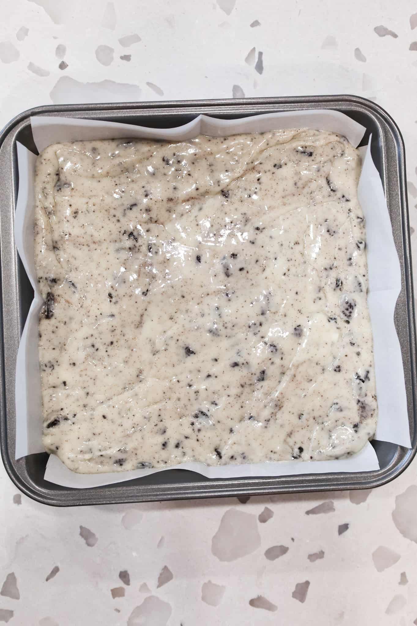 Oreo fudge mixture in a parchment lined baking pan
