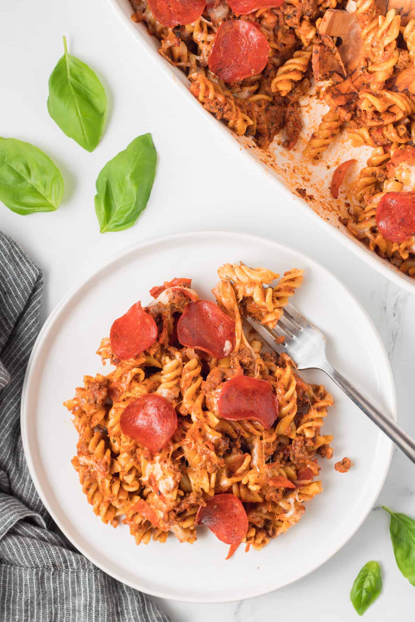 Pizza Casserole is a delicious baked rotini pasta loaded with ground beef, pizza sauce, pepperoni and mozzarella cheese.