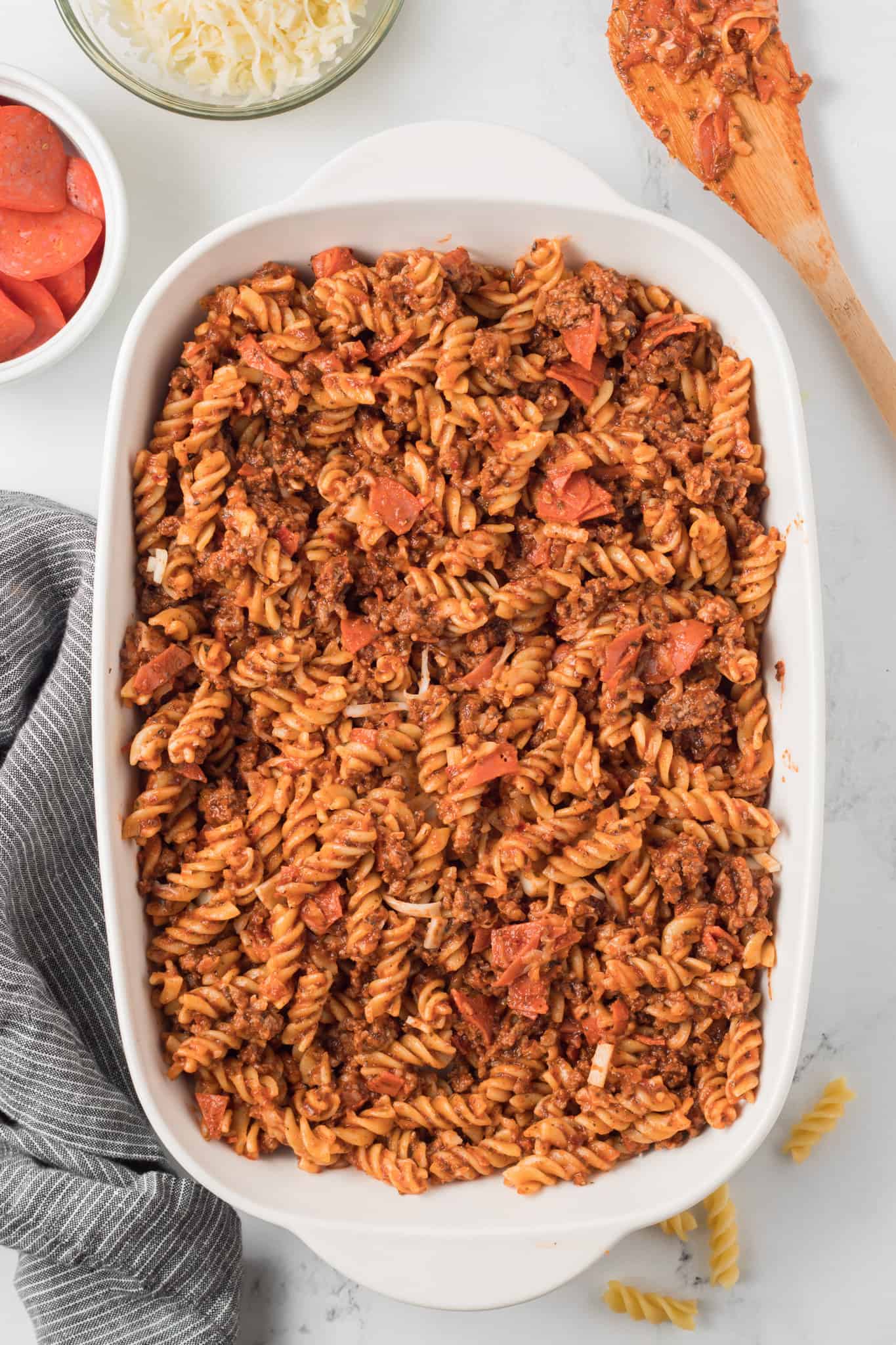 rotini pizza pasta mixture in a baking dish