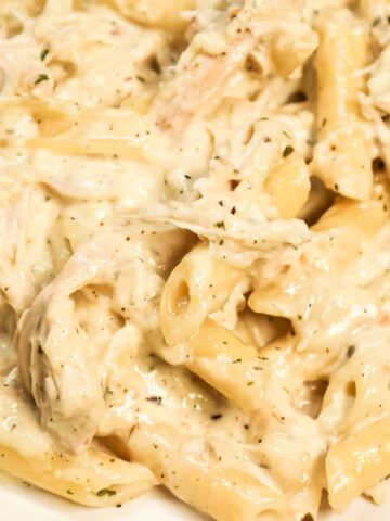 Chicken Alfredo Penne is an easy stove top pasta recipe loaded with shredded rotisserie chicken all tossed in a creamy garlic parmesan sauce.