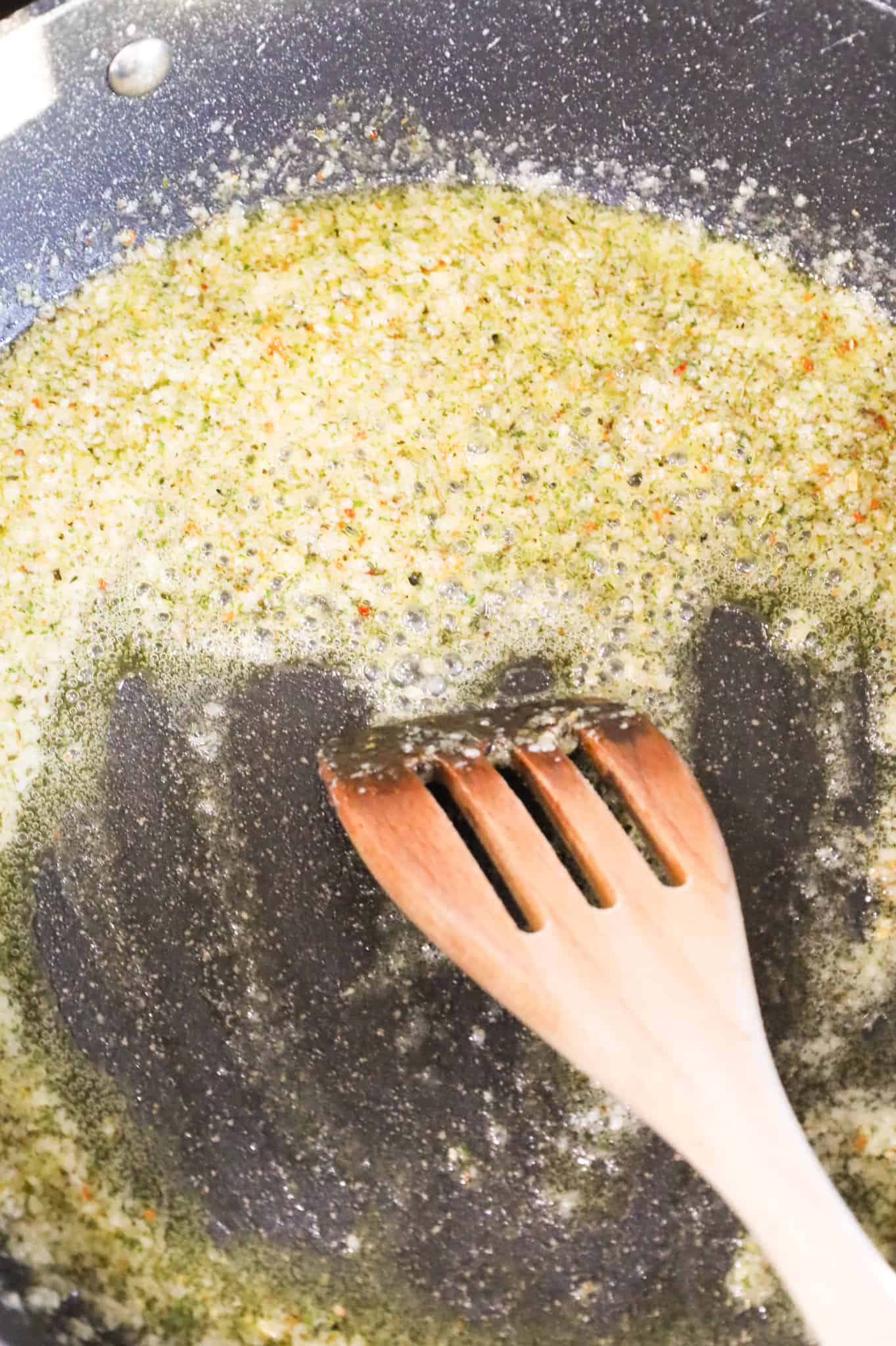 melted butter, garlic puree and Italian seasoning cooking in a skillet