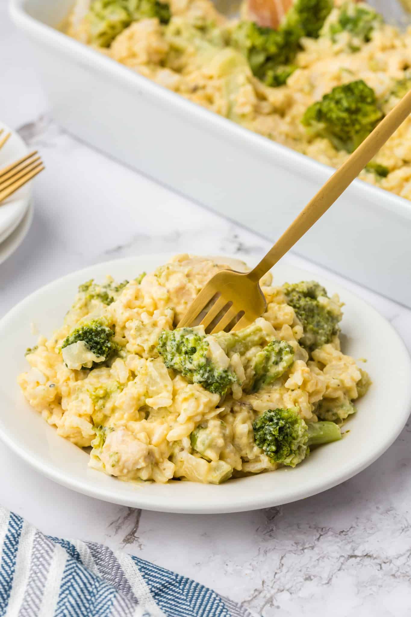 Chicken Broccoli Rice Casserole is an easy chicken dinner recipe made with chicken breasts, cream of broccoli soup, broccoli florets, white rice, cream cheese, sour cream Velveeta and shredded Colby jack cheese.