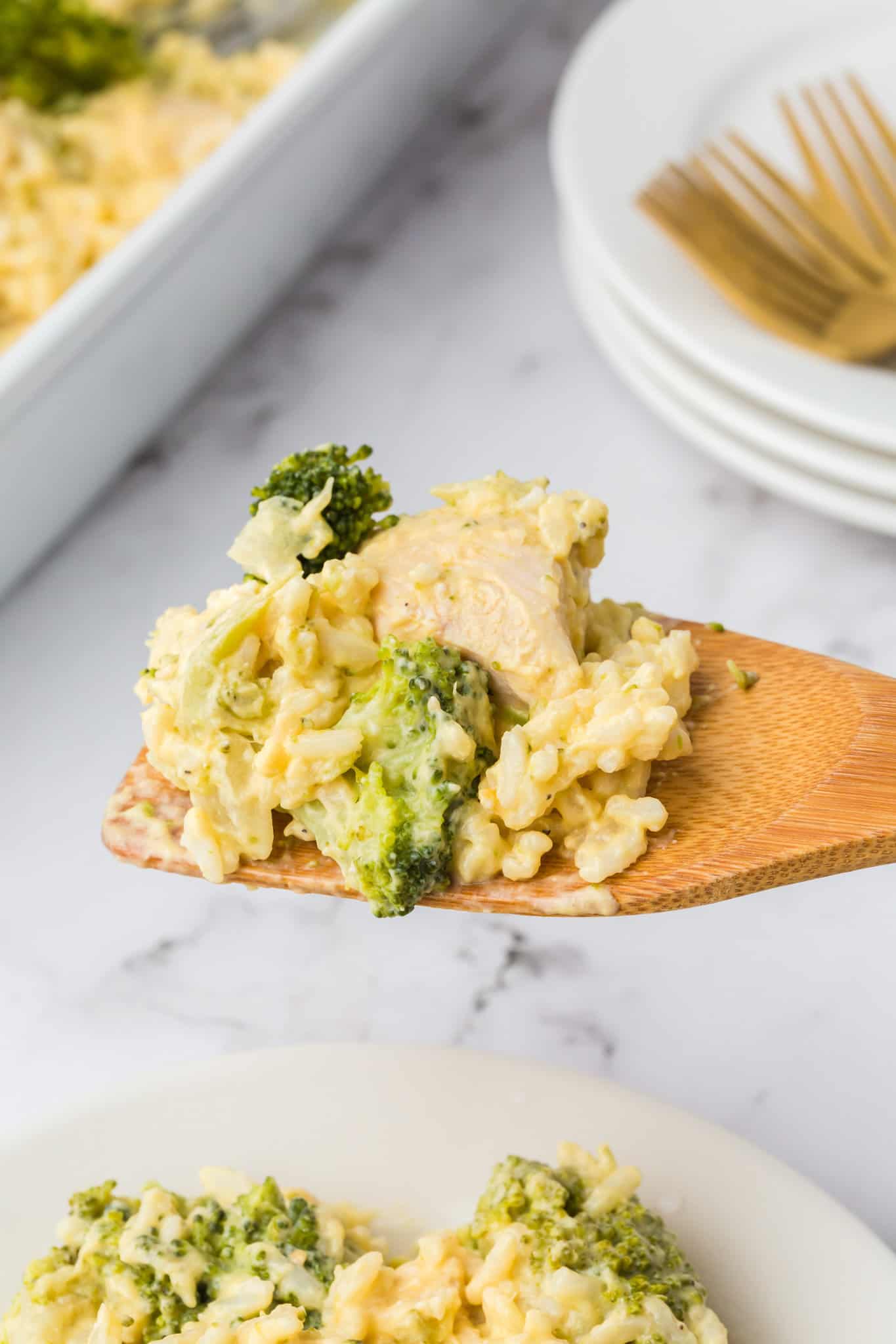 Chicken Broccoli Rice Casserole is an easy chicken dinner recipe made with chicken breasts, cream of broccoli soup, broccoli florets, white rice, cream cheese, sour cream Velveeta and shredded Colby jack cheese.