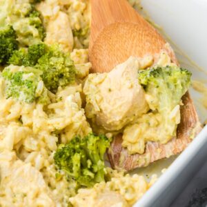 Chicken Broccoli Rice Casserole is an easy chicken dinner recipe made with chicken breasts, cream of broccoli soup, broccoli florets, white rice, cream cheese, sour cream Velveeta and shredded Colby jack cheese.