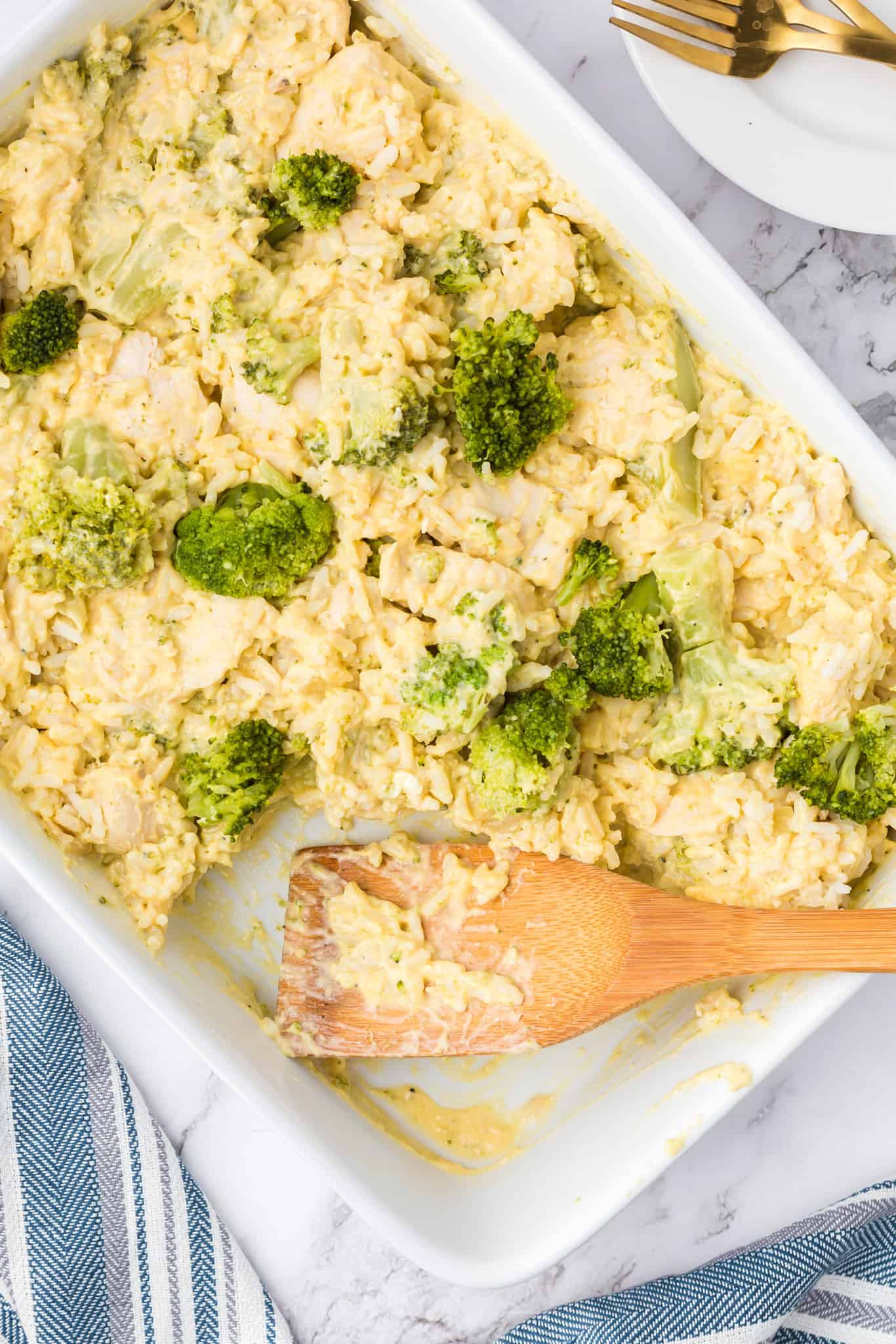 Chicken Broccoli Rice Casserole is an easy chicken dinner recipe made with chicken breasts, cream of broccoli soup, broccoli florets, white rice, cream cheese, sour cream Velveeta and shredded Colby jack cheese.