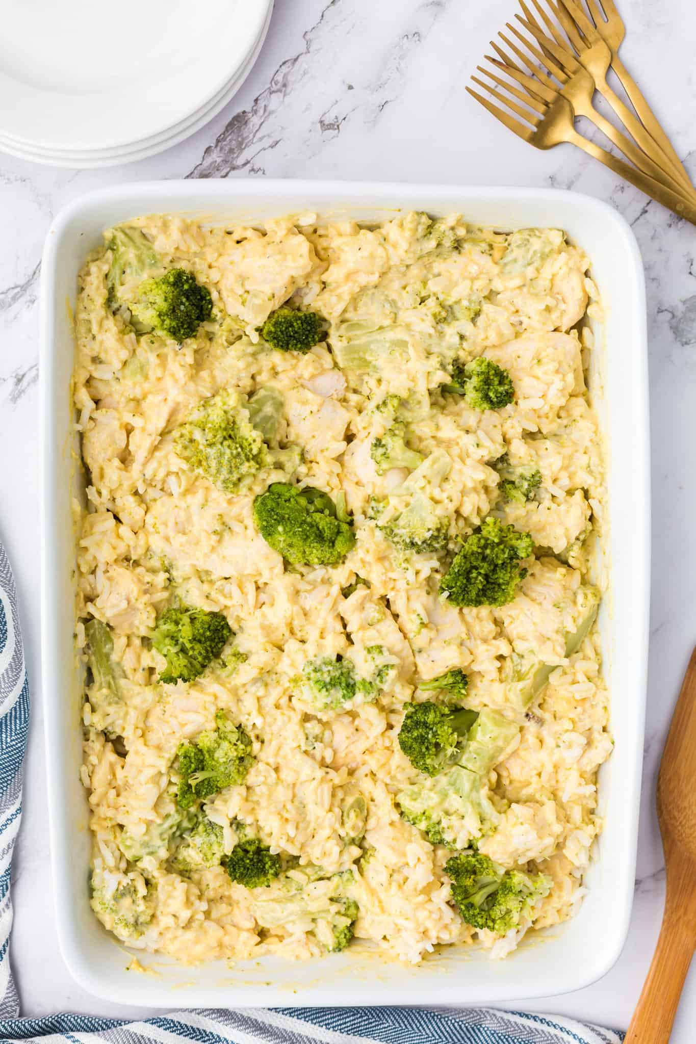 Chicken Broccoli Rice Casserole is an easy chicken dinner recipe made with chicken breasts, cream of broccoli soup, broccoli florets, white rice, cream cheese, sour cream Velveeta and shredded Colby jack cheese.