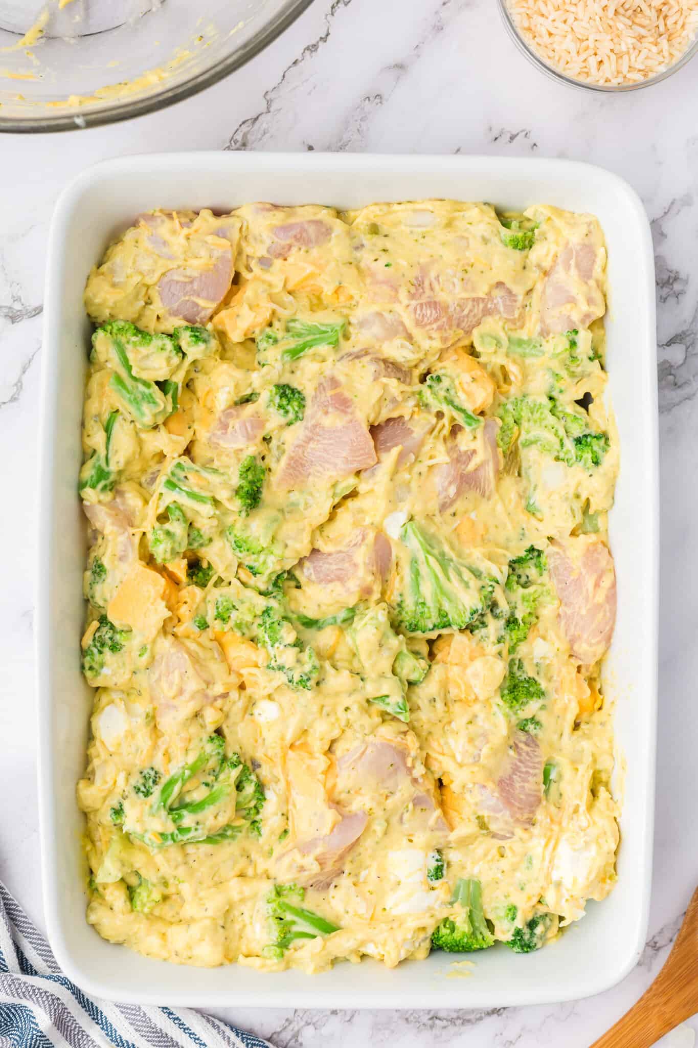 cheesy chicken and broccoli mixture in a casserole dish before baking