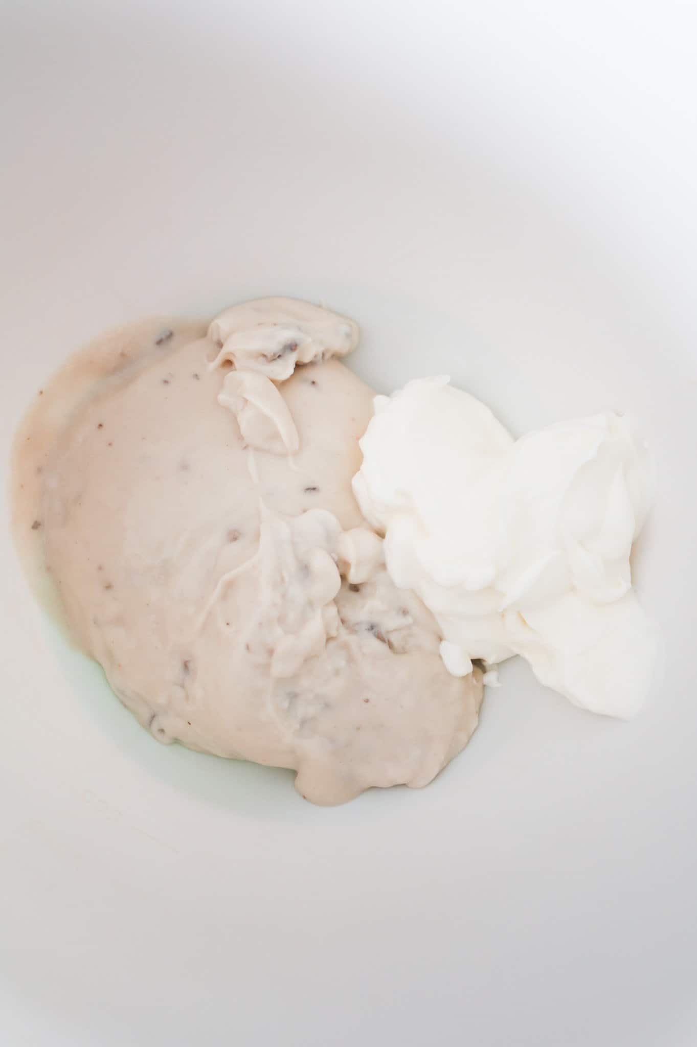 sour cream and cream of mushroom soup in a mixing bowl