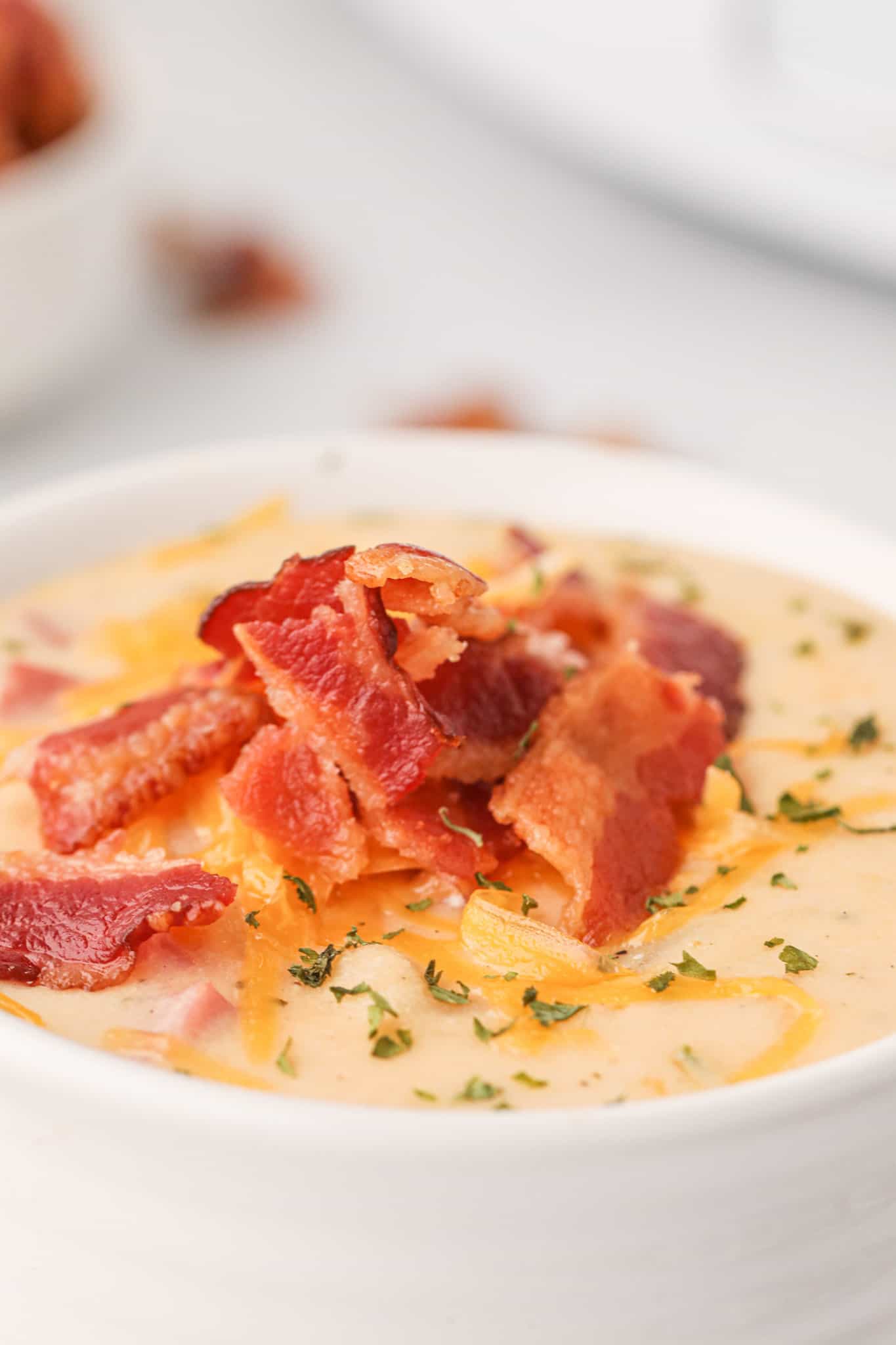 Crock Pot Loaded Potato Soup is a hearty slow cooker soup recipe loaded with diced hash brown potatoes, ham, cheddar cheese, cream cheese and bacon.