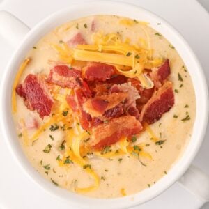 Crock Pot Loaded Potato Soup is a hearty slow cooker soup recipe loaded with diced hash brown potatoes, ham, cheddar cheese, cream cheese and bacon.