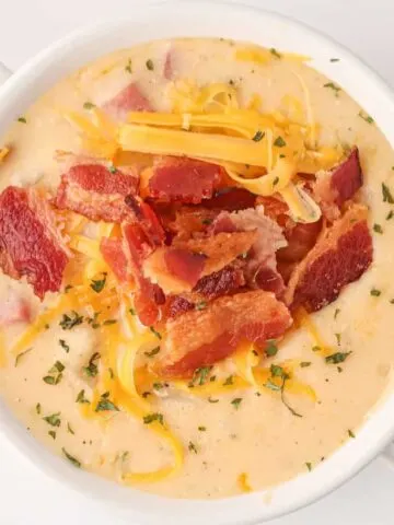 Crock Pot Loaded Potato Soup is a hearty slow cooker soup recipe loaded with diced hash brown potatoes, ham, cheddar cheese, cream cheese and bacon.