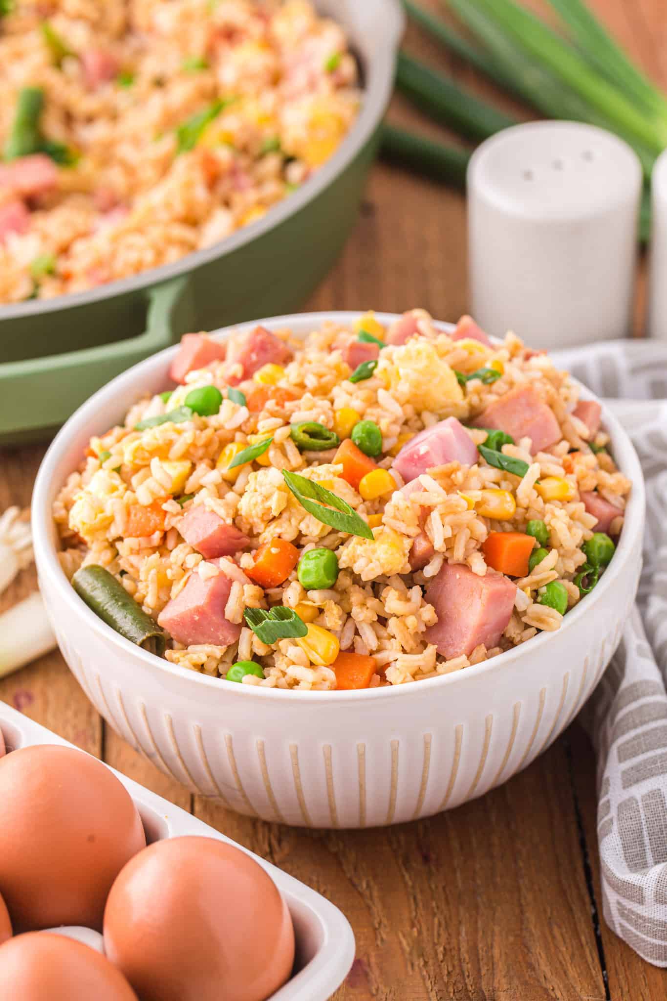 Ham Fried Rice is a delicious dinner or side dish recipe using diced ham, scrambled eggs and frozen mixed veggies all tossed with rice, soy sauce and fried rice seasoning mix.