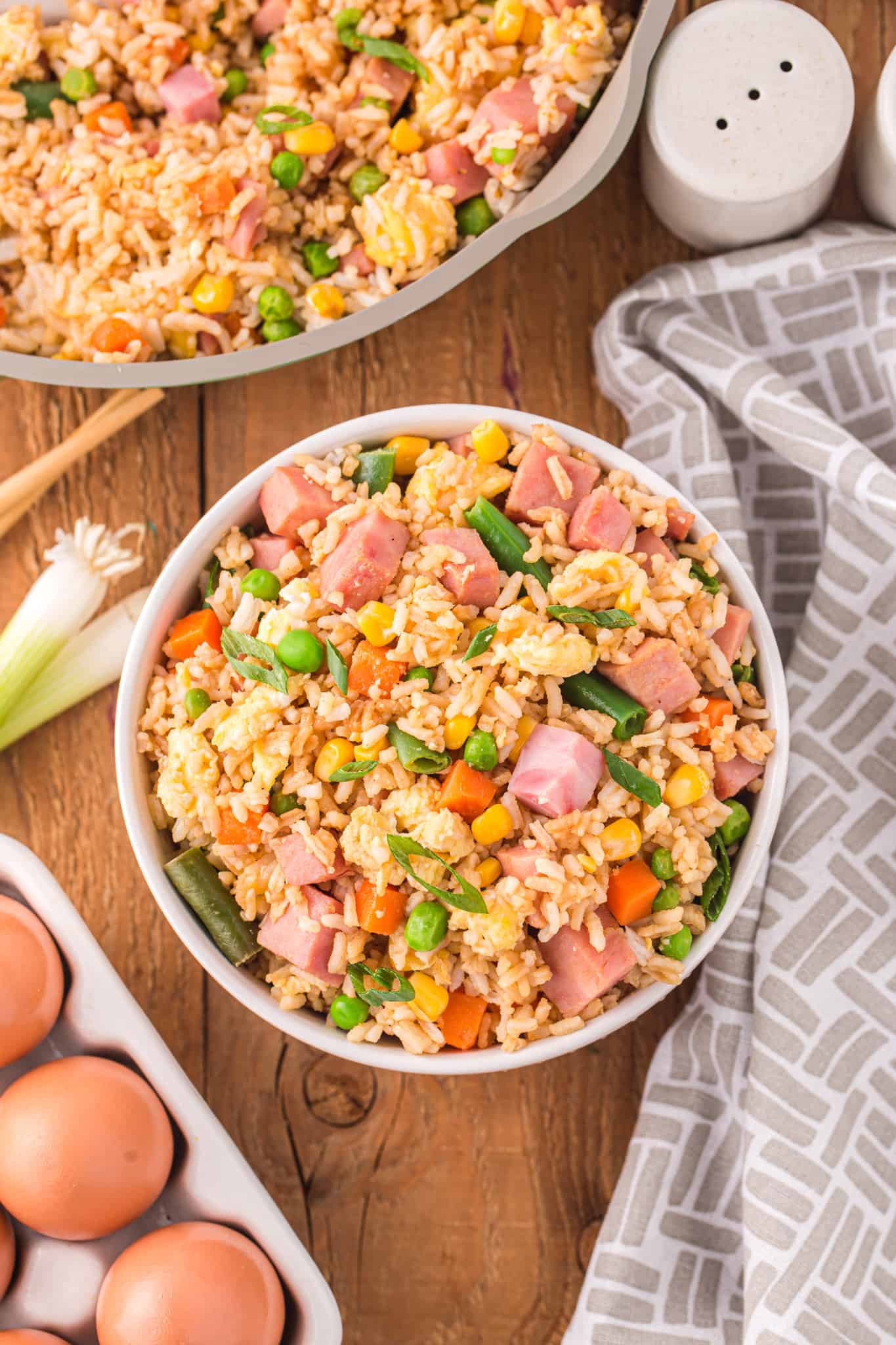 Ham Fried Rice is a delicious dinner or side dish recipe using diced ham, scrambled eggs and frozen mixed veggies all tossed with rice, soy sauce and fried rice seasoning mix.