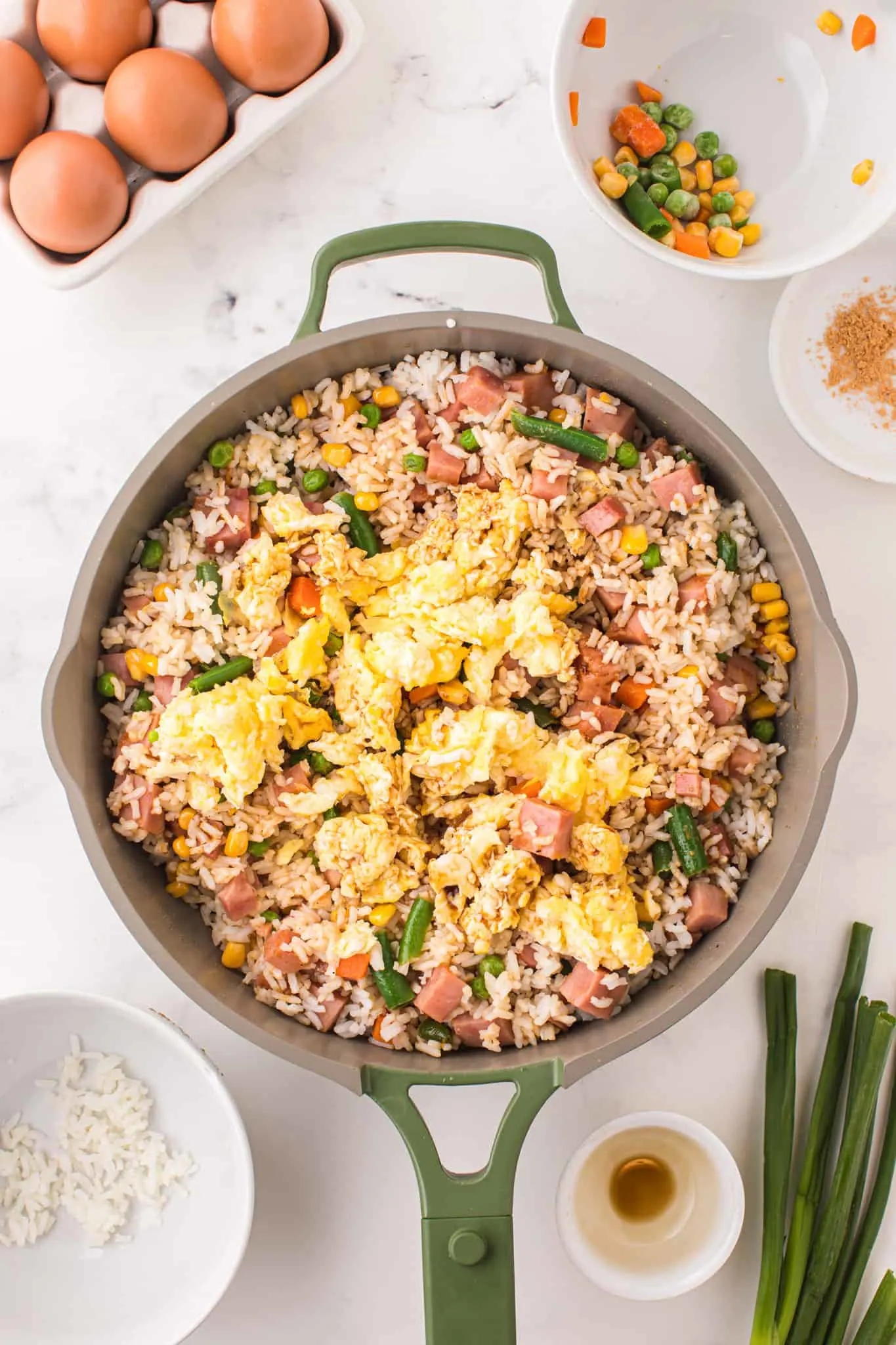 scrambled eggs added to skillet with rice, vegetable and diced ham mixture