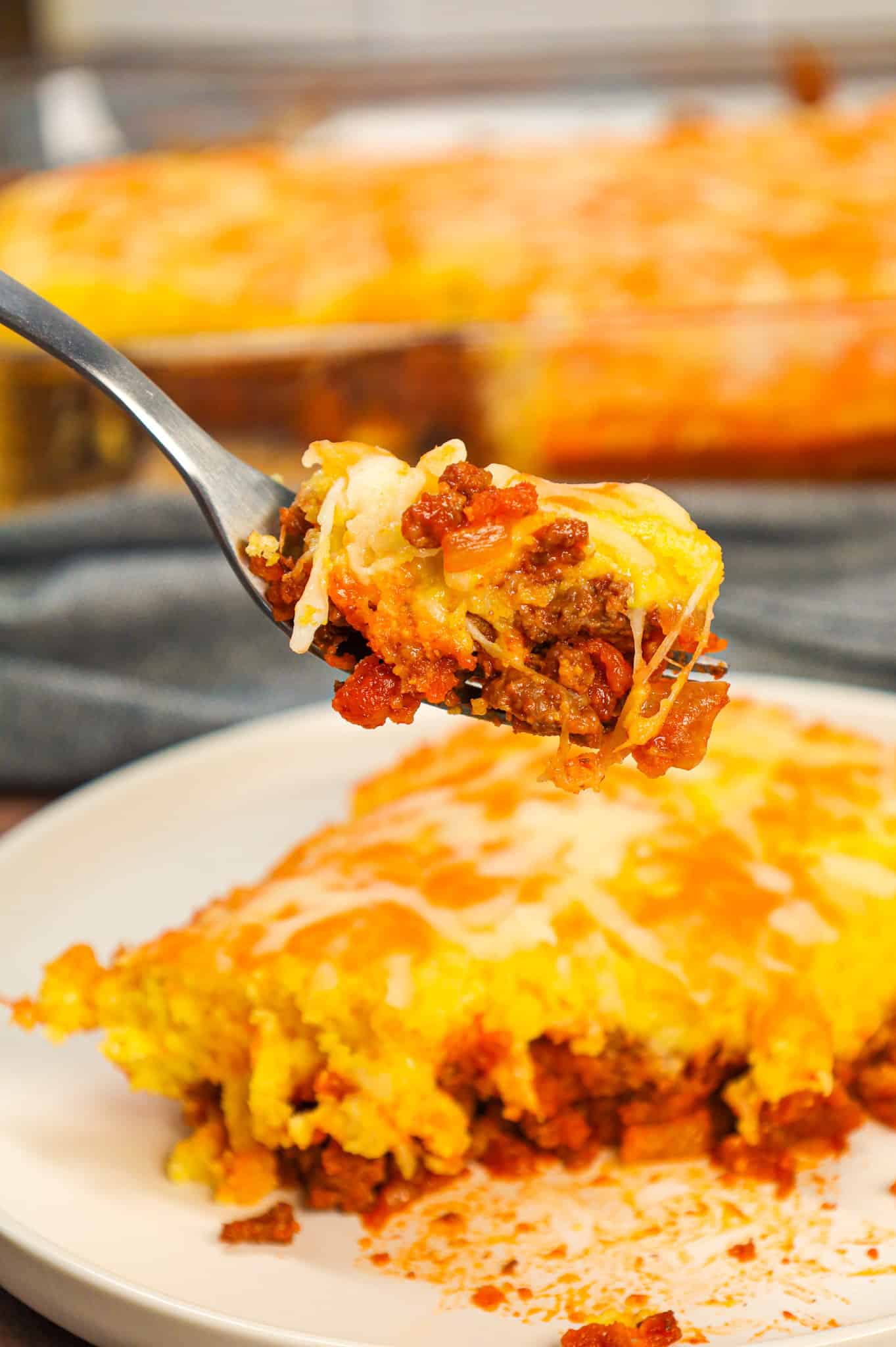 Sloppy Joe Cornbread Casserole is a hearty hamburger casserole with a base of crumbled ground beef in sloppy joe sauce topped with a layer of Jiffy cornbread.