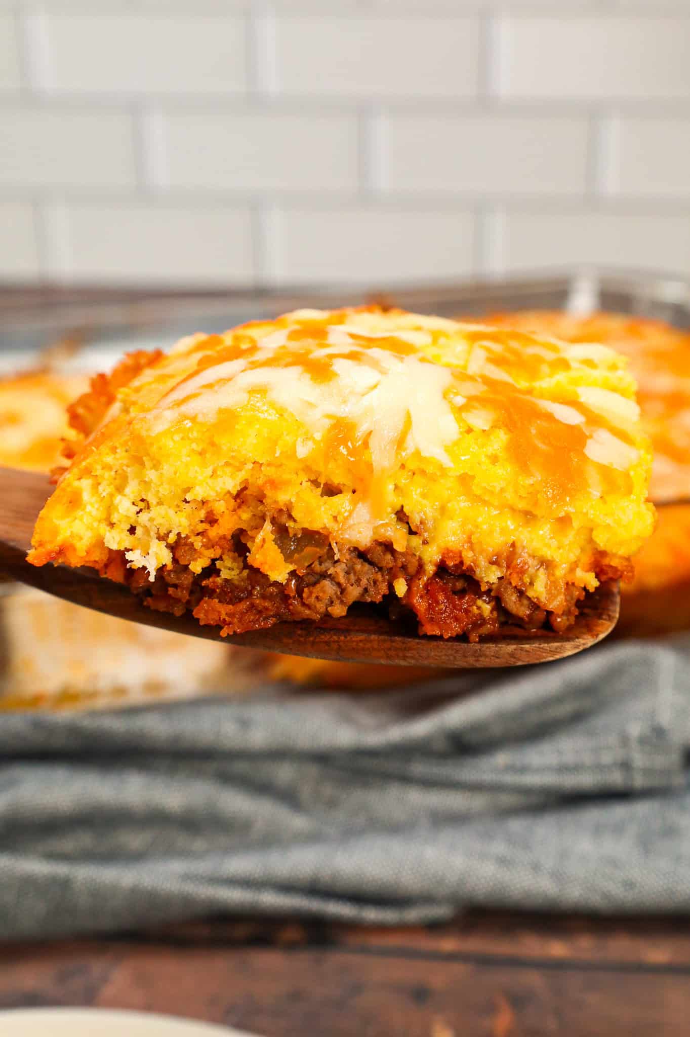 Sloppy Joe Cornbread Casserole is a hearty hamburger casserole with a base of crumbled ground beef in sloppy joe sauce topped with a layer of Jiffy cornbread.