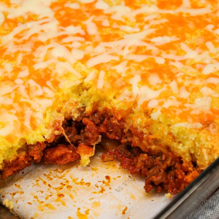 Sloppy Joe Cornbread Casserole is a hearty hamburger casserole with a base of crumbled ground beef in sloppy joe sauce topped with a layer of Jiffy cornbread.