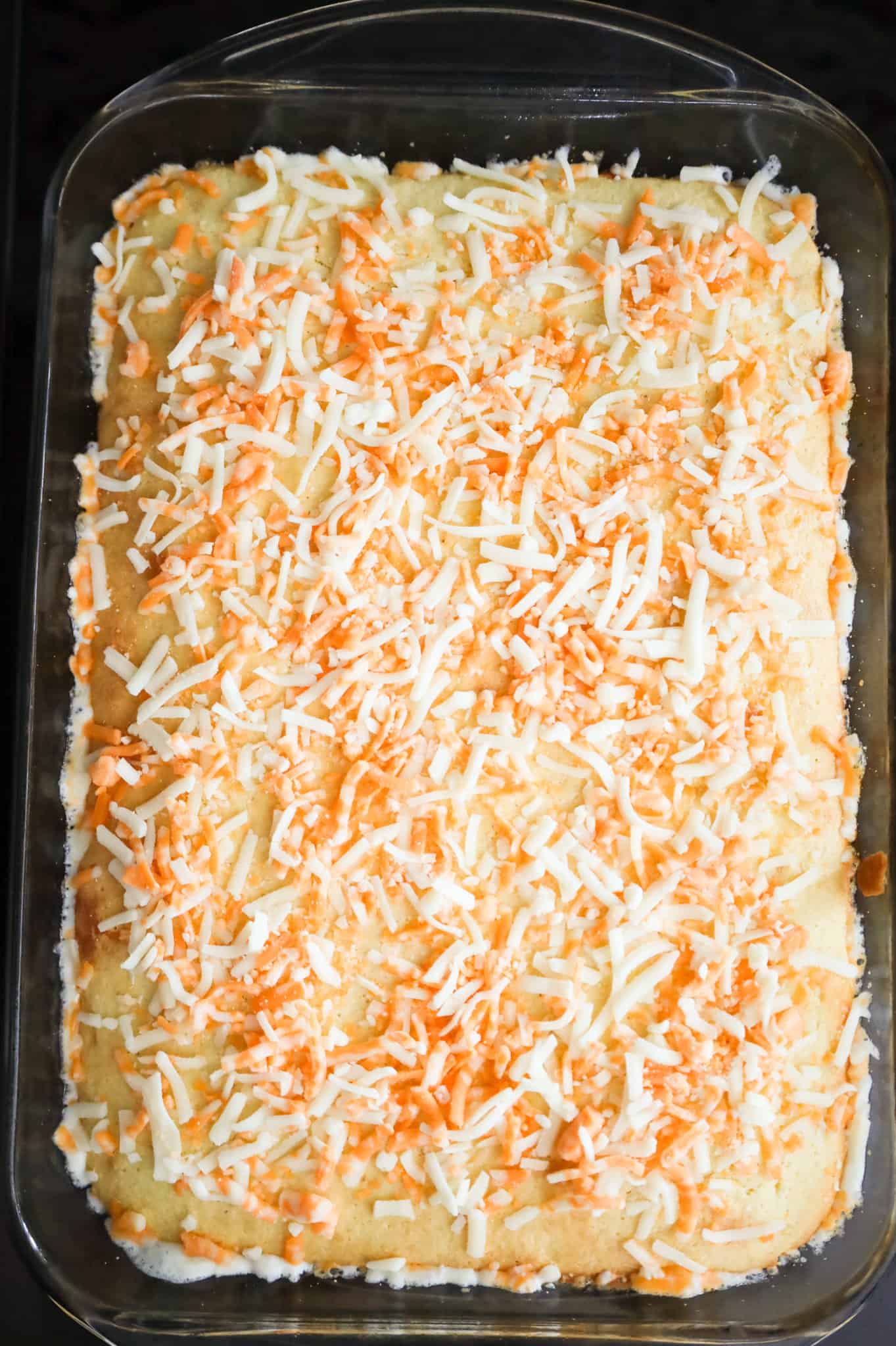 shredded cheese sprinkled on top of baked cornbread casserole