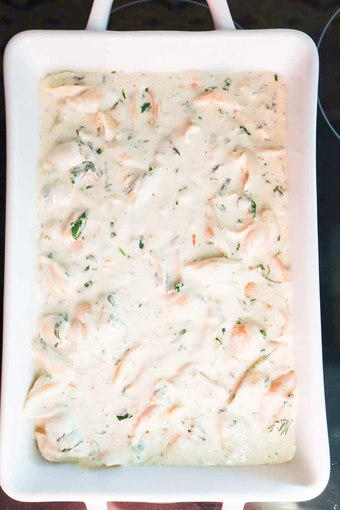 creamy spinach pasta shells in a baking dish