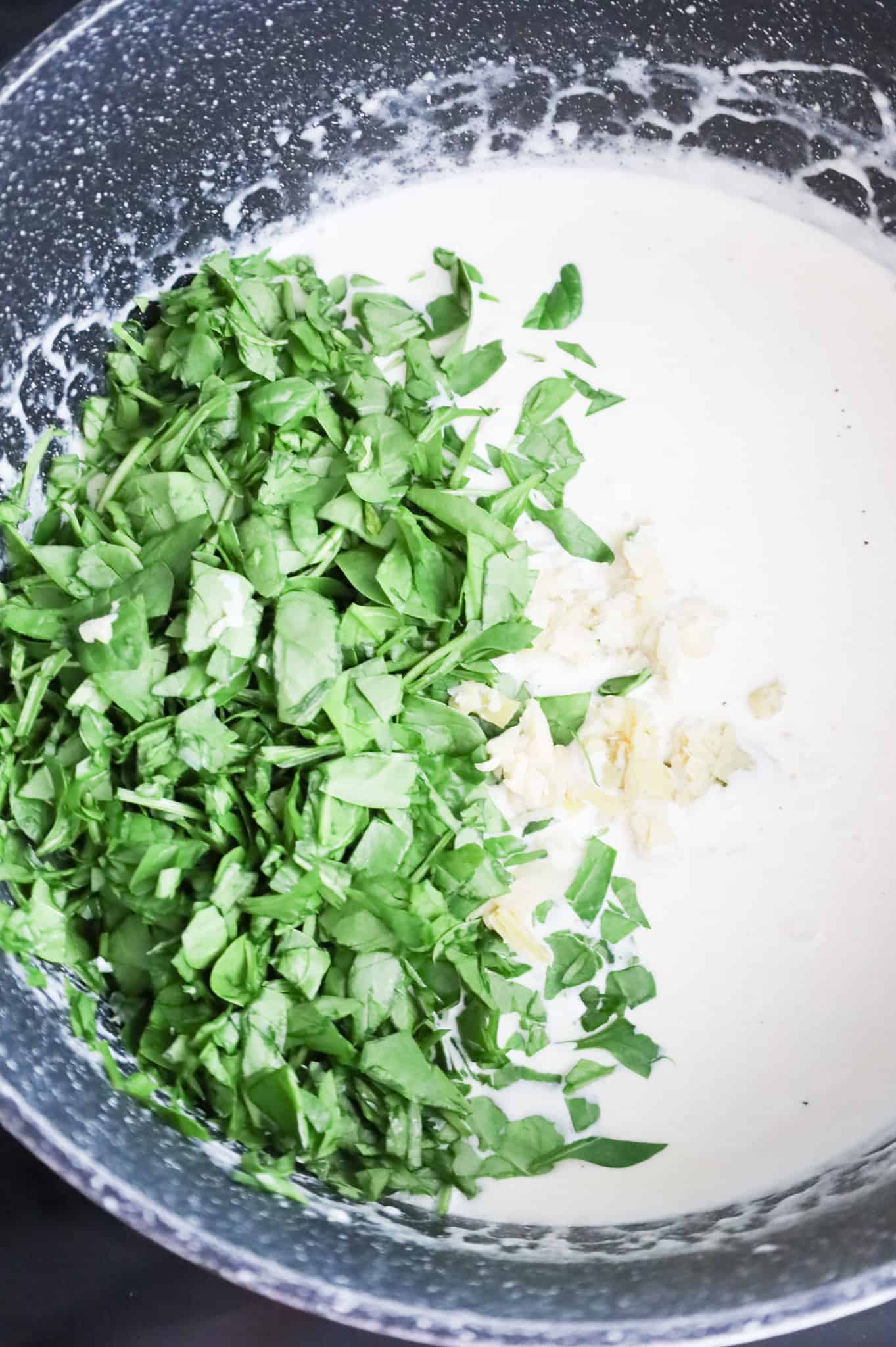 chopped spinach and artichokes added to pot with cream sauce