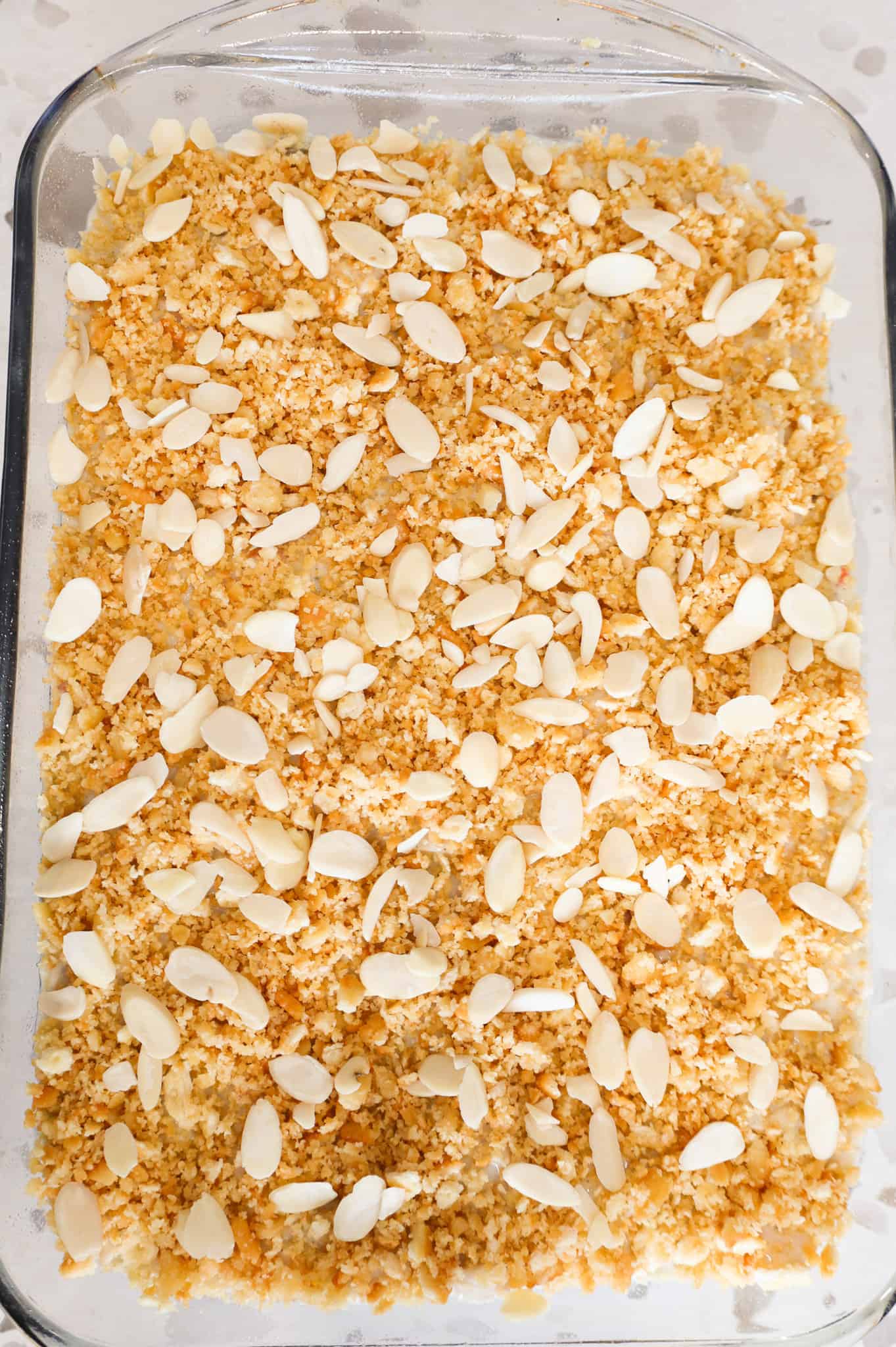 sliced almonds and Ritz cracker crumbs on top of chicken and rice casserole