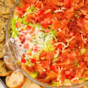 BLT Dip is an easy cold dip recipe loaded with mayo, ranch dressing, cheddar cheese, shredded lettuce, diced tomatoes and bacon.