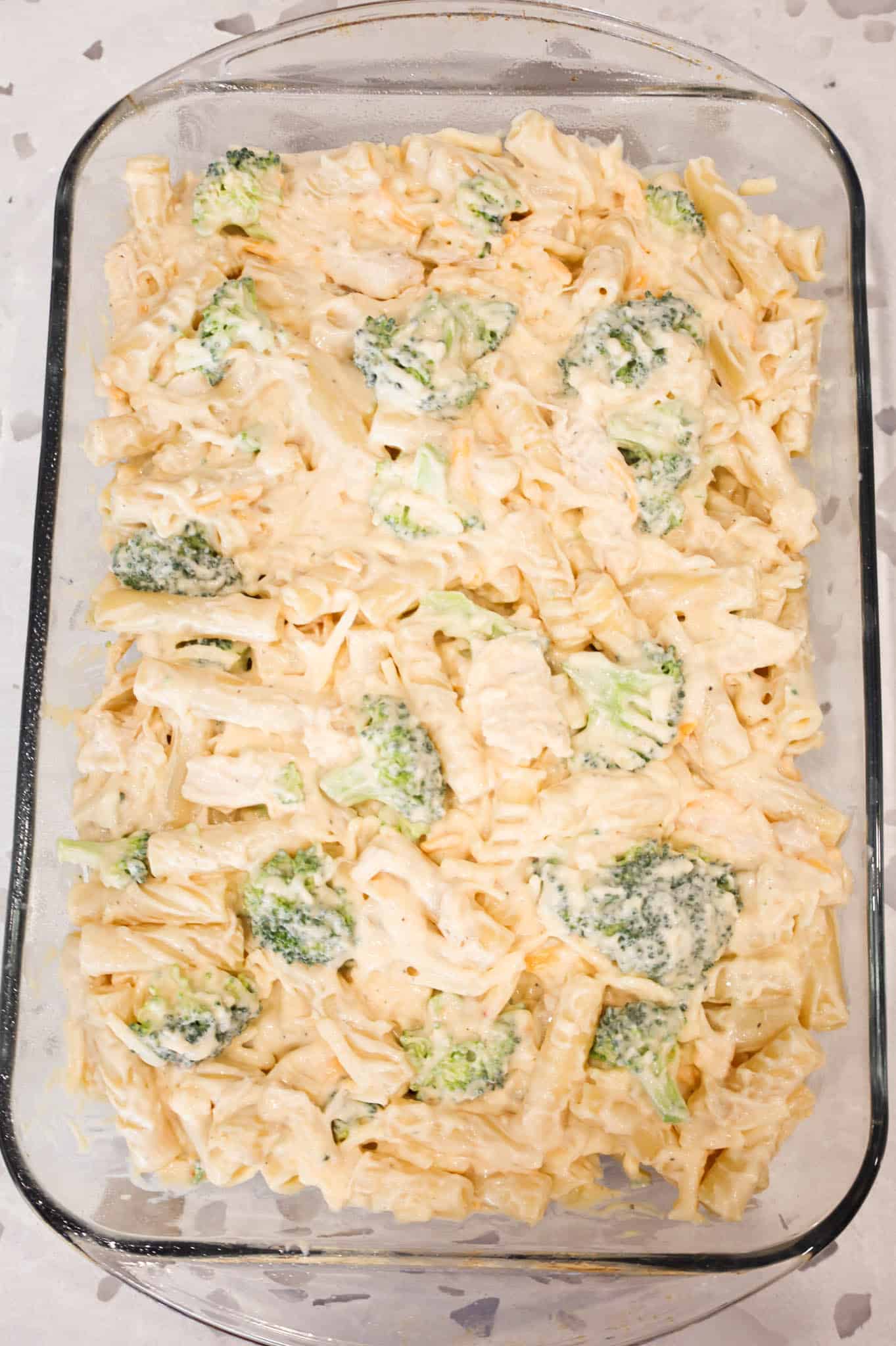 creamy chicken and broccoli ziti mixture in a baking dish