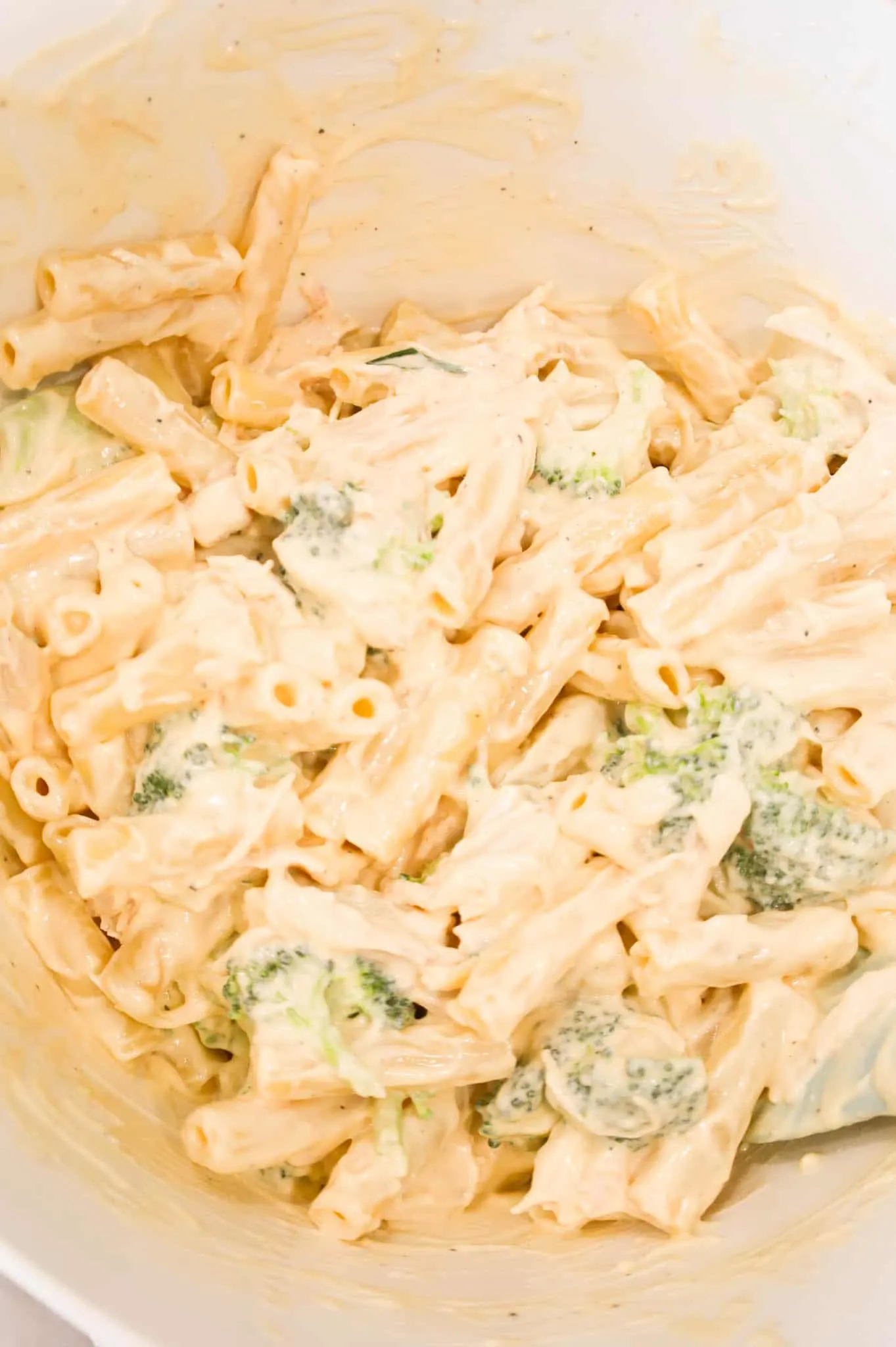 creamy ziti, broccoli and chicken mixture in a mixing bowl