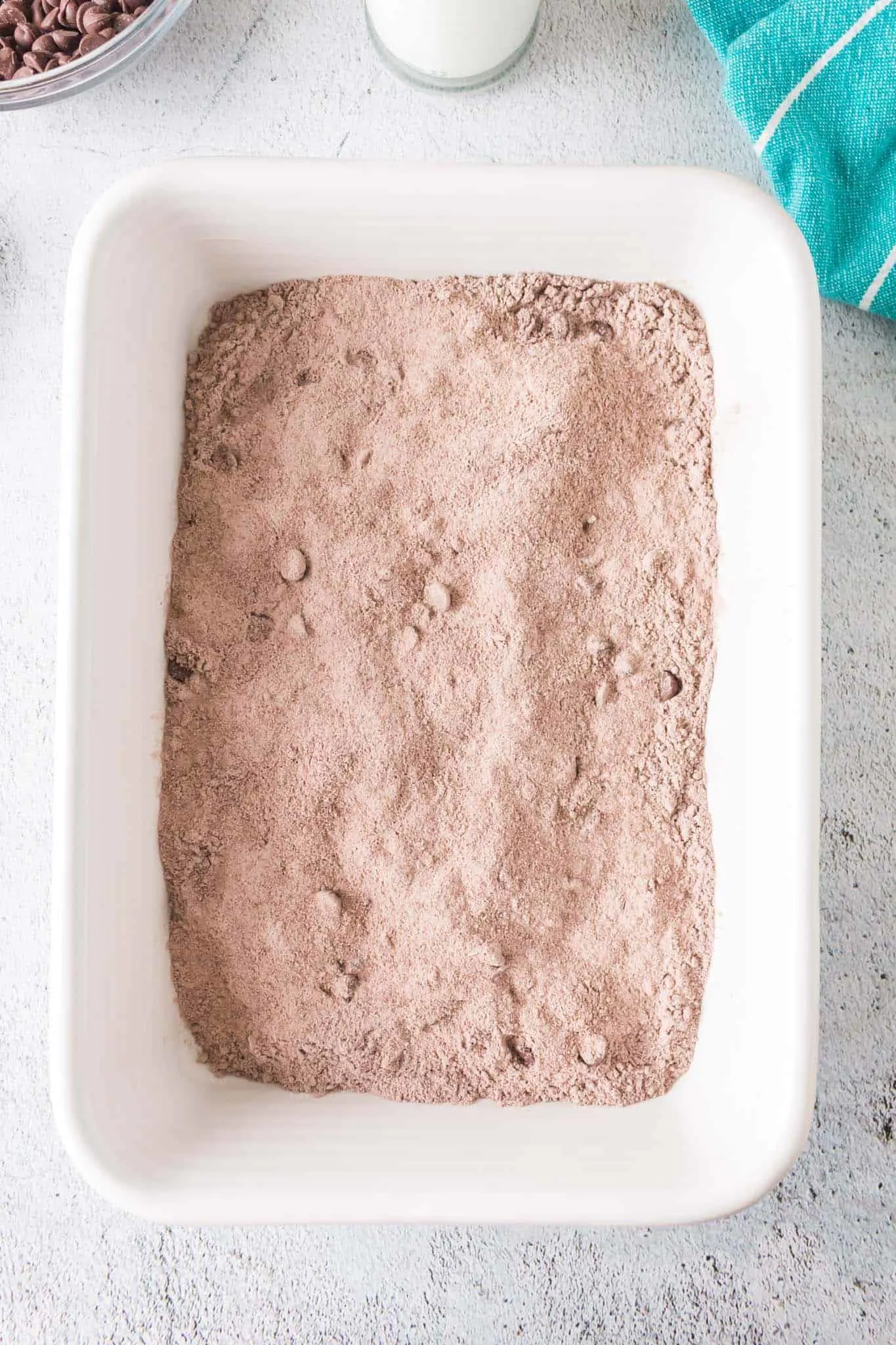 chocolate cake mix, pudding mix and chocolate chips stirred together in a baking dish