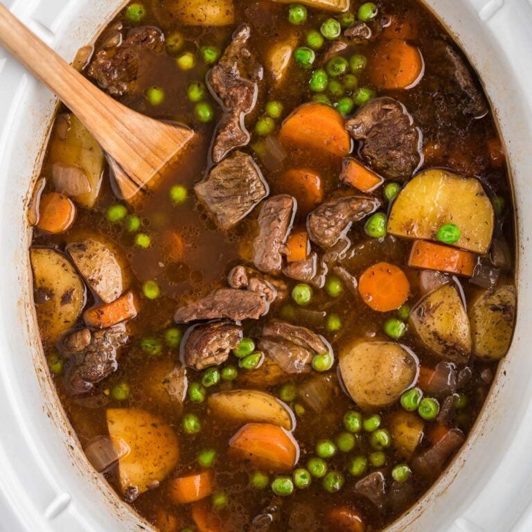 Crock Pot Beef Stew is a hearty slow cooker dish loaded with chunks of beef, potatoes, carrots, onions and peas all in a delicious red wine beef broth.