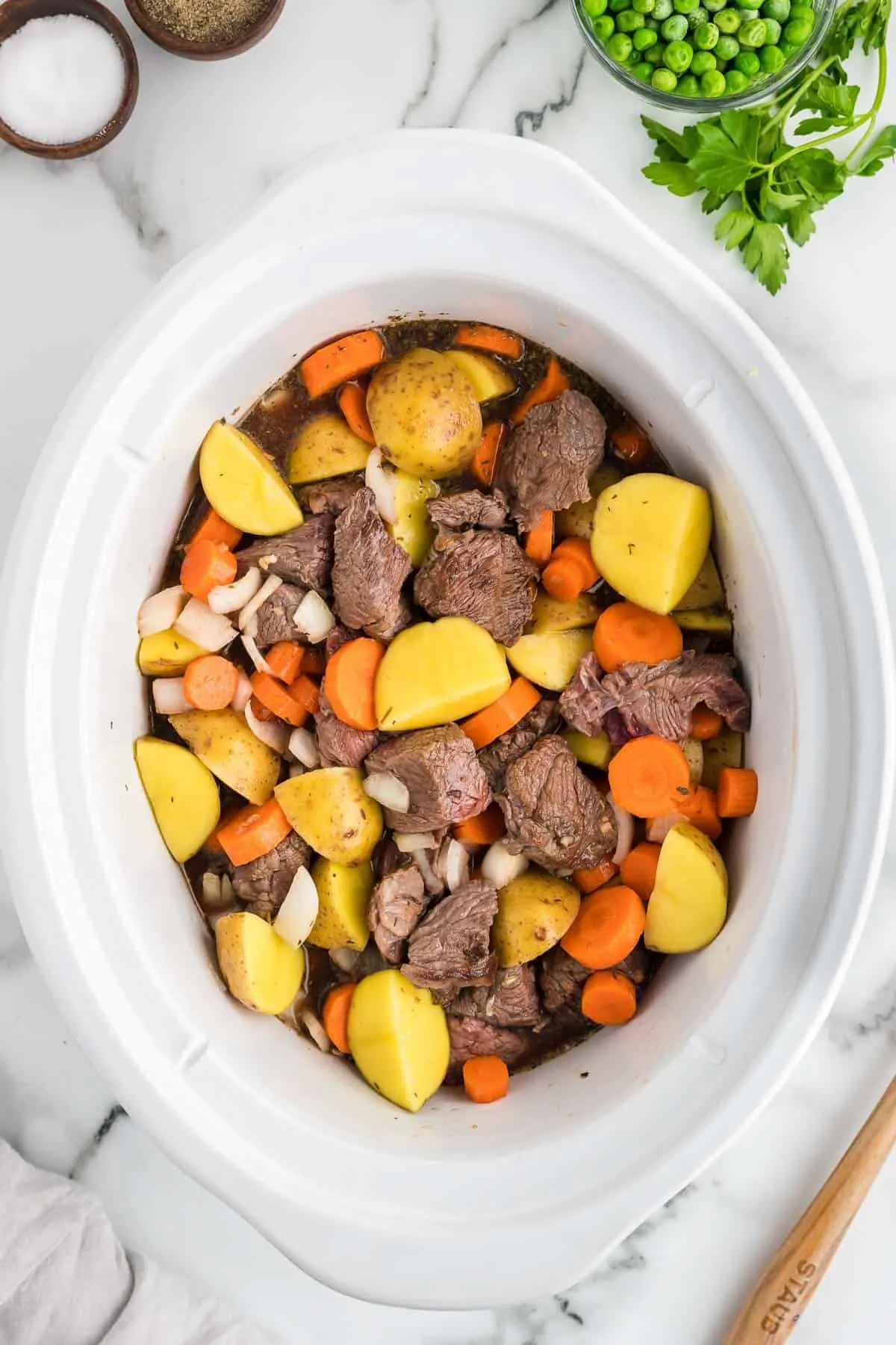 beef chunks, potatoes, carrots and onions in a crock pot