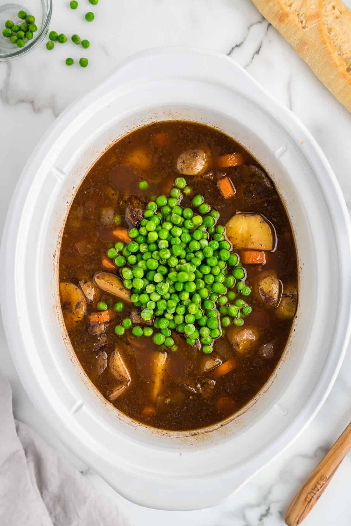 frozen peas added to crock pot with beef stew