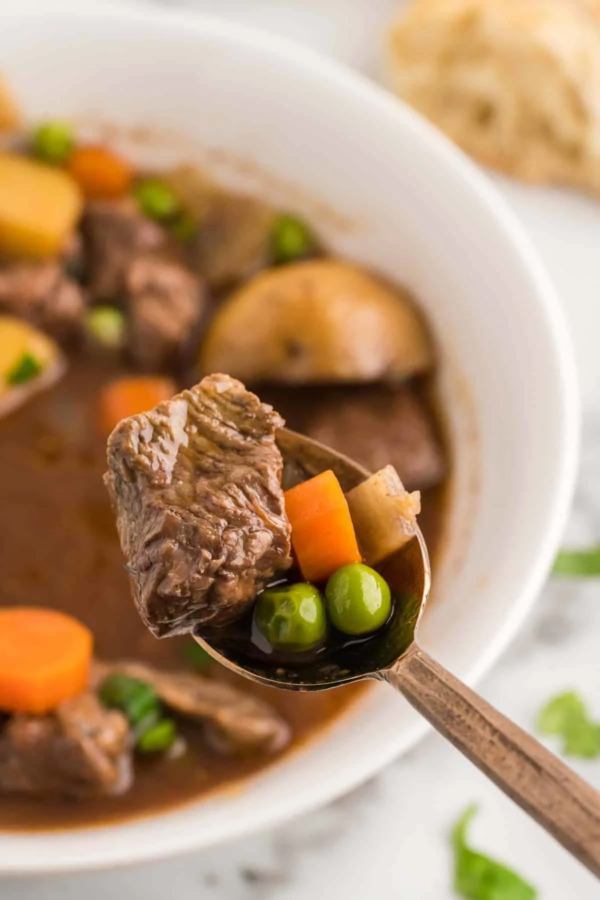 Crock Pot Beef Stew is a hearty slow cooker dish loaded with chunks of beef, potatoes, carrots, onions and peas all in a delicious red wine beef broth.