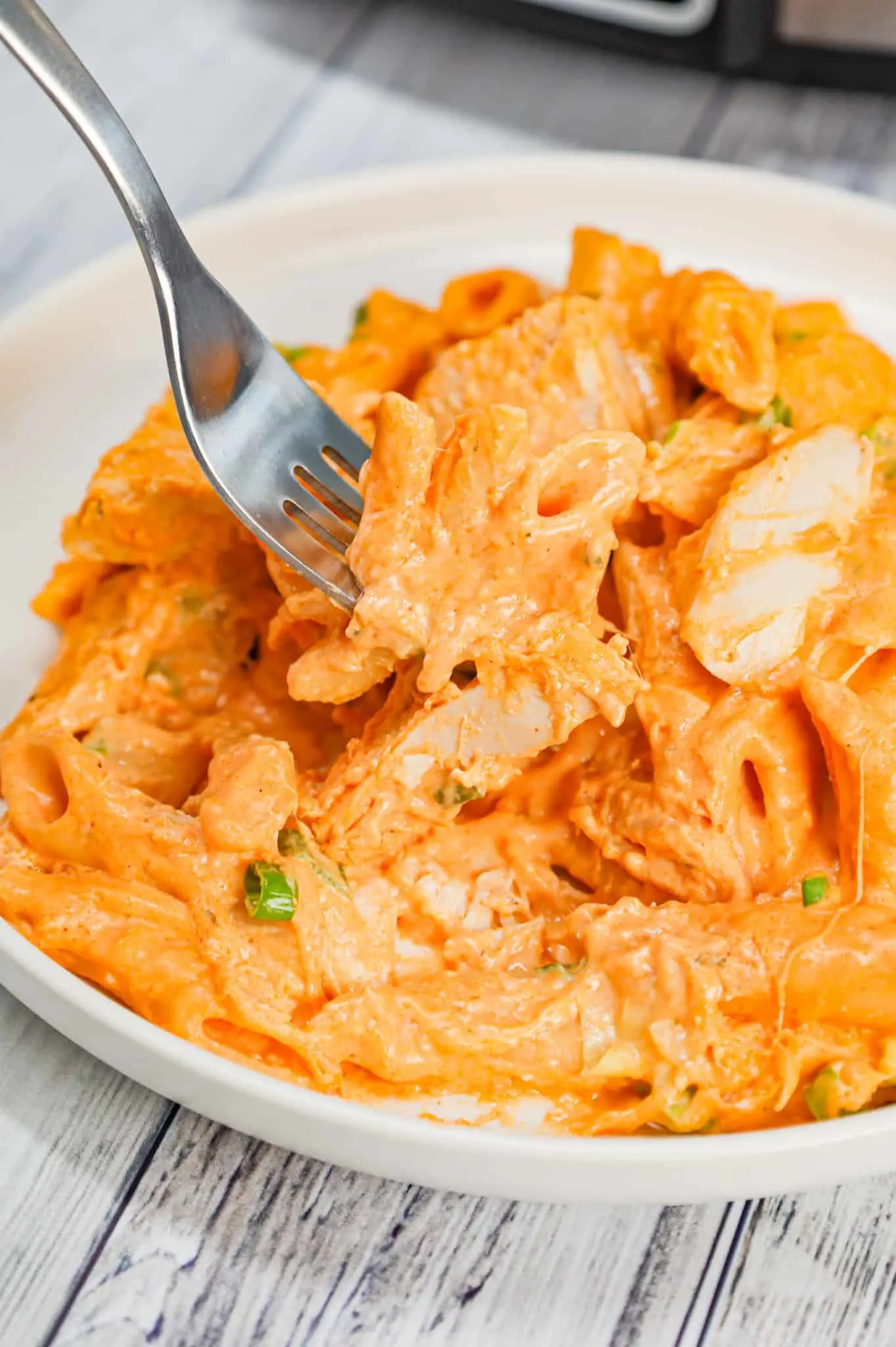 Crock Pot Buffalo Chicken Pasta is an easy slow cooker penne recipe loaded with Buffalo sauce, ranch dressing, cream cheese, breast chunks, cheddar, mozzarella and chopped green onions.