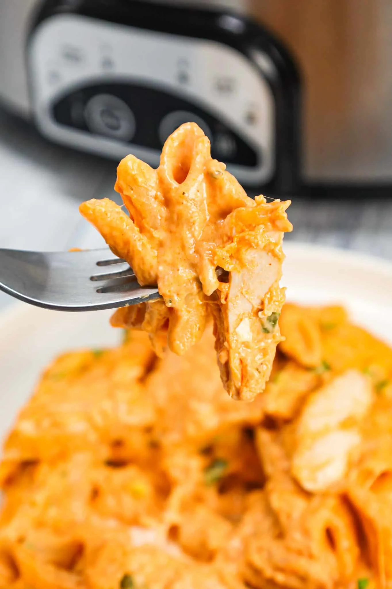 Crock Pot Buffalo Chicken Pasta is an easy slow cooker penne recipe loaded with Buffalo sauce, ranch dressing, cream cheese, breast chunks, cheddar, mozzarella and chopped green onions.