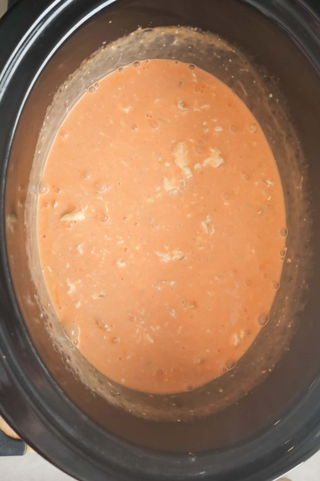 buffalo chicken pasta cooking in a crock pot