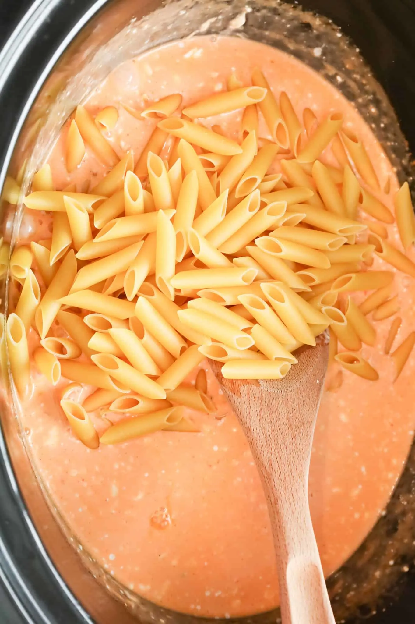 uncooked penne pasta noodles added to crock pot