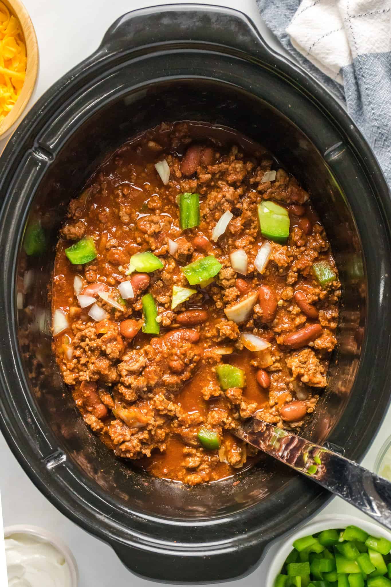 Crock Pot Chili is a hearty slow cooker ground beef chili recipe loaded with onions, bell peppers and kidney beans.