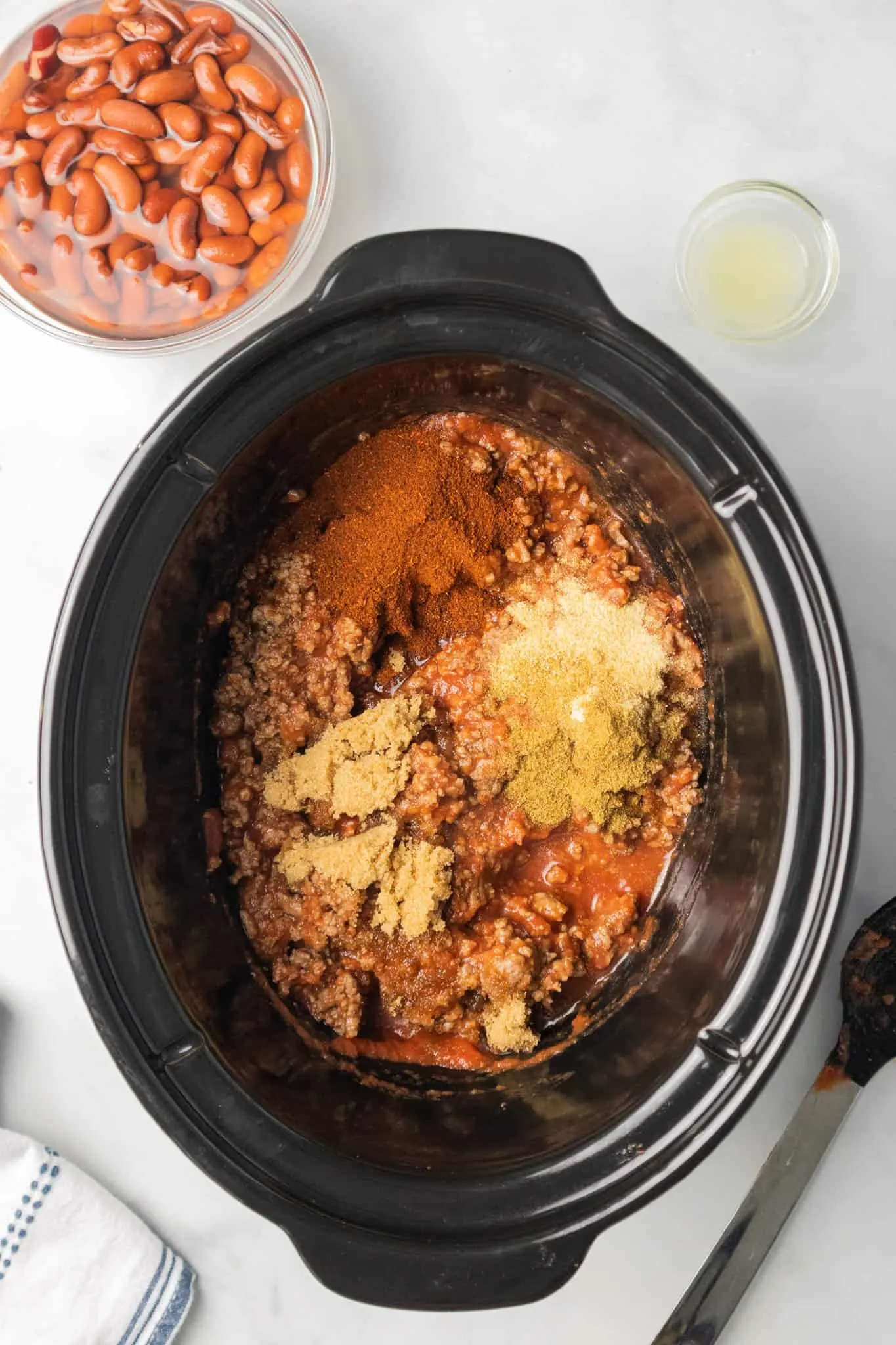 spices, ground beef and tomato sauce in a Crock Pot