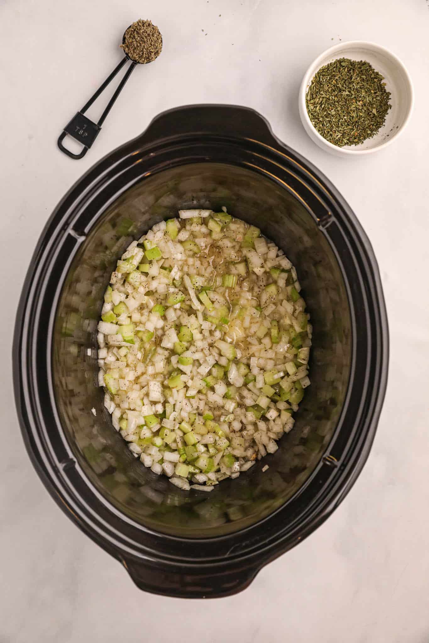 butter and chopped veggies in a crock pot